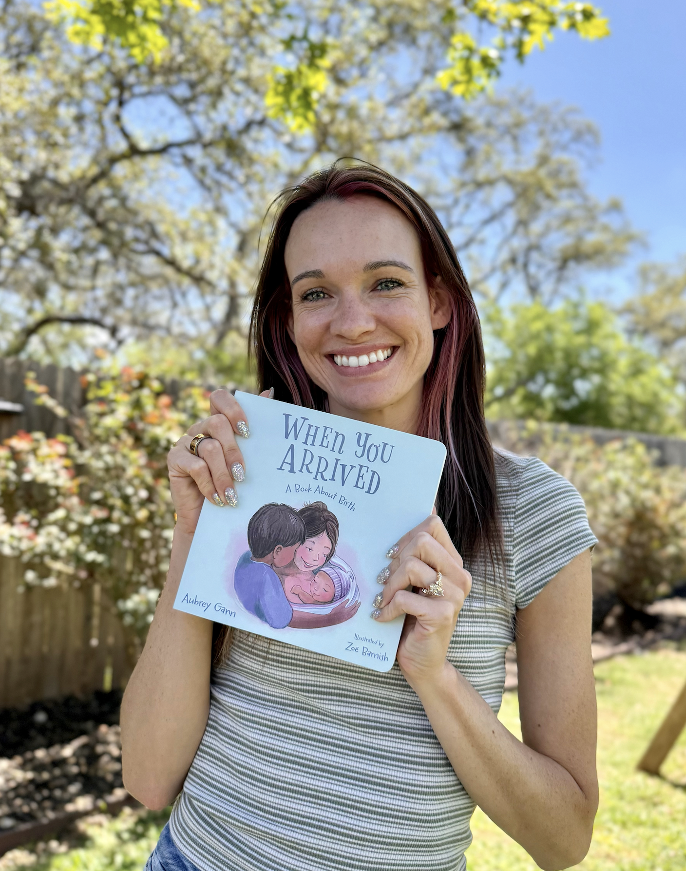 A doula holding the book she wrote about birth.