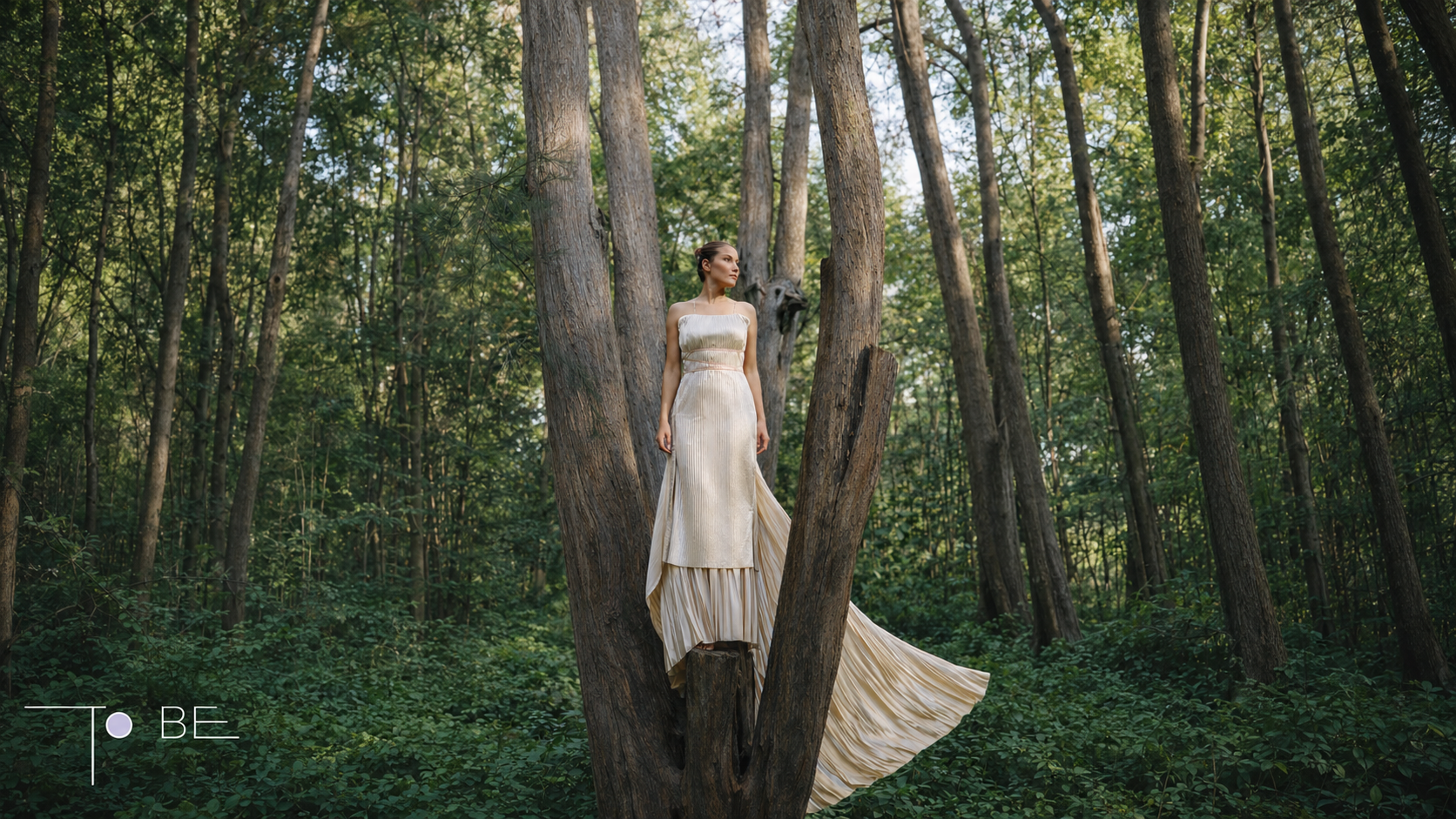 To BE Haute Couture Bride fashion dress image showing a flowing strapless gown in a forest setting, connecting garment design, movement, and visual storytelling.