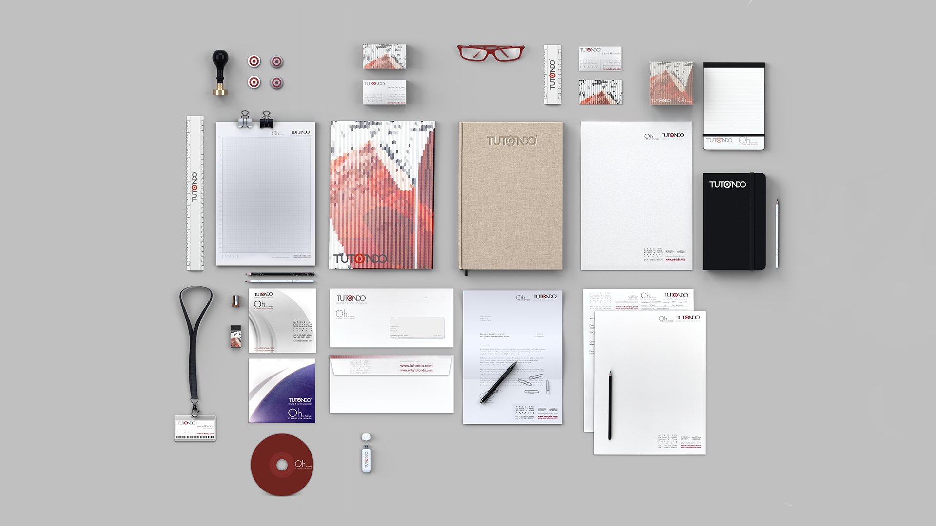 Tutondo coordinated brand identity applied to notebooks, business cards, folders, pens, USB drive, ruler, and lanyard.