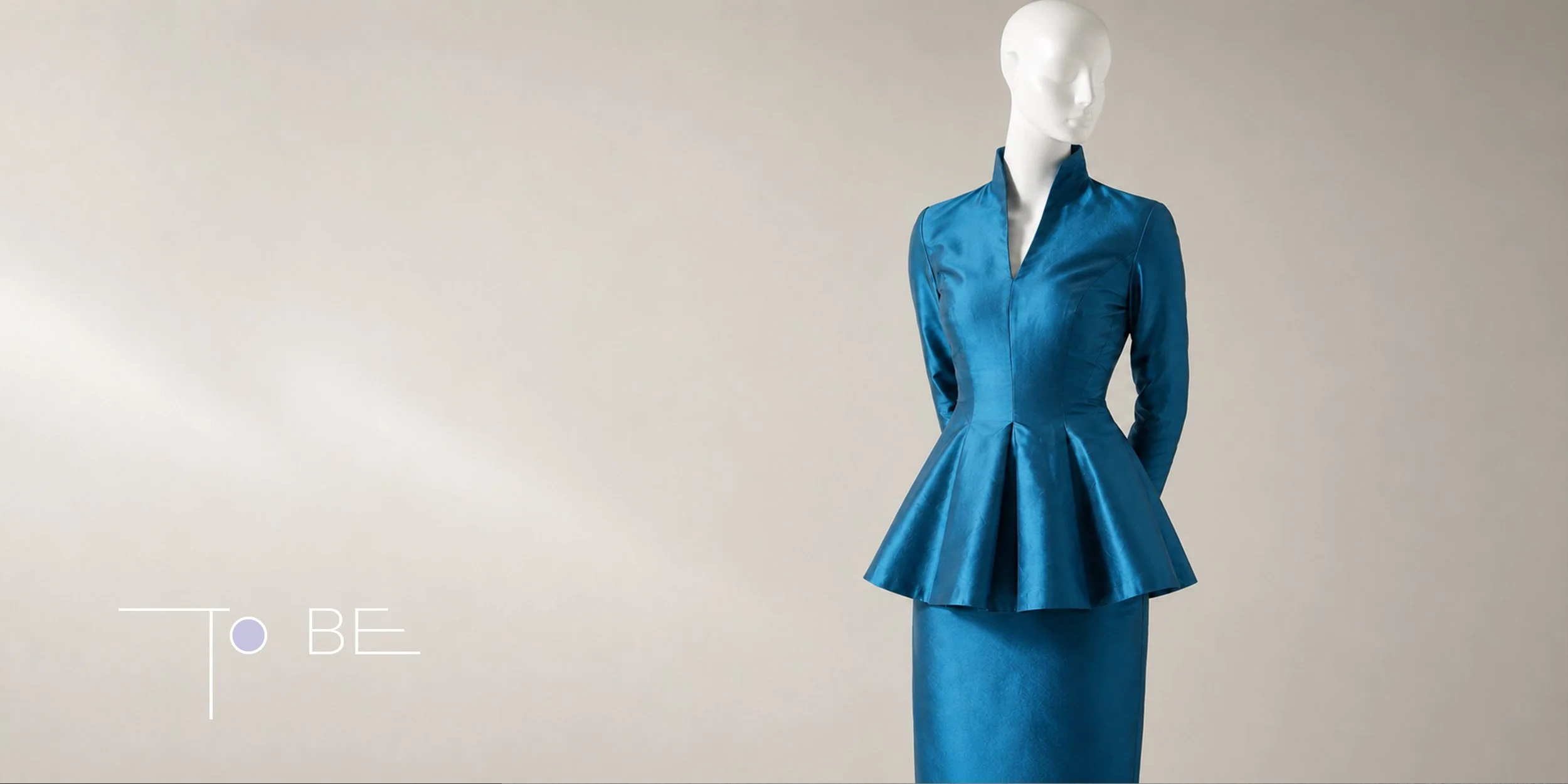 To BE fashion design showing a structured blue dress on a mannequin, exploring garment volume, pleating, and formal silhouette design.