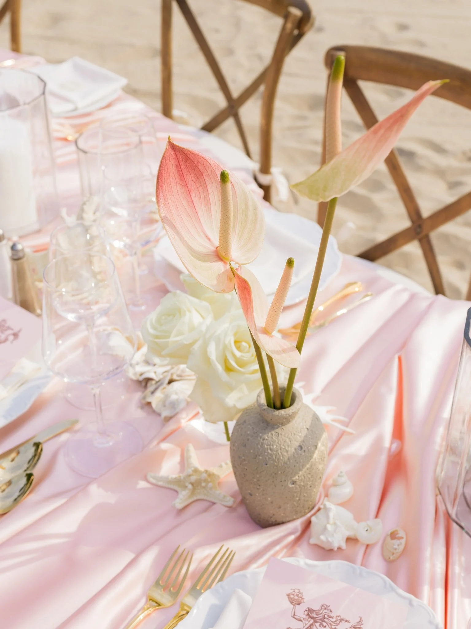 Alfresco dining setup on the sand at a private beachside residence, Fairfield County coastal bridal shower