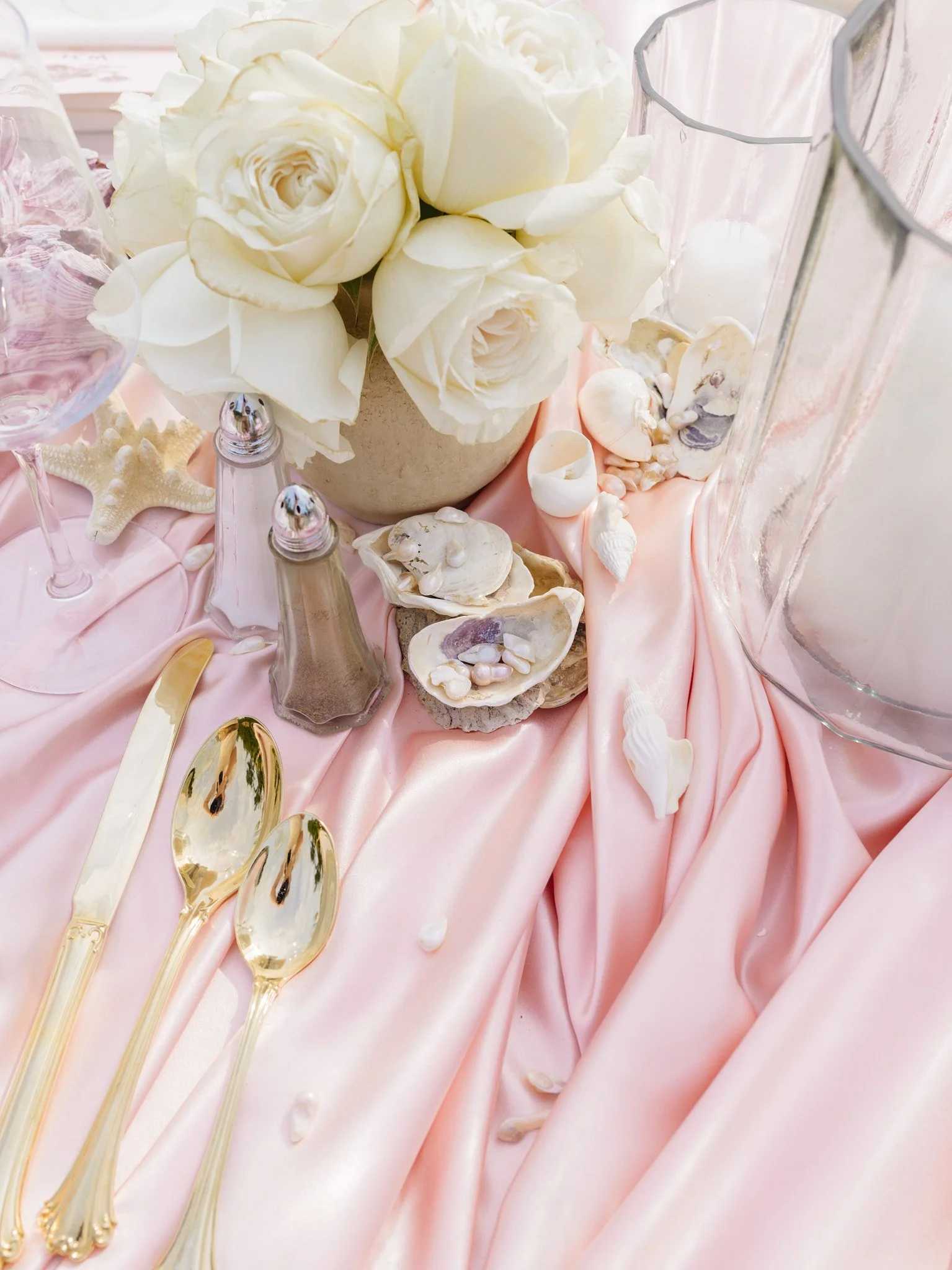 Close-up texture shot of oyster shells and pearls gathered from the beach, tablescape detail