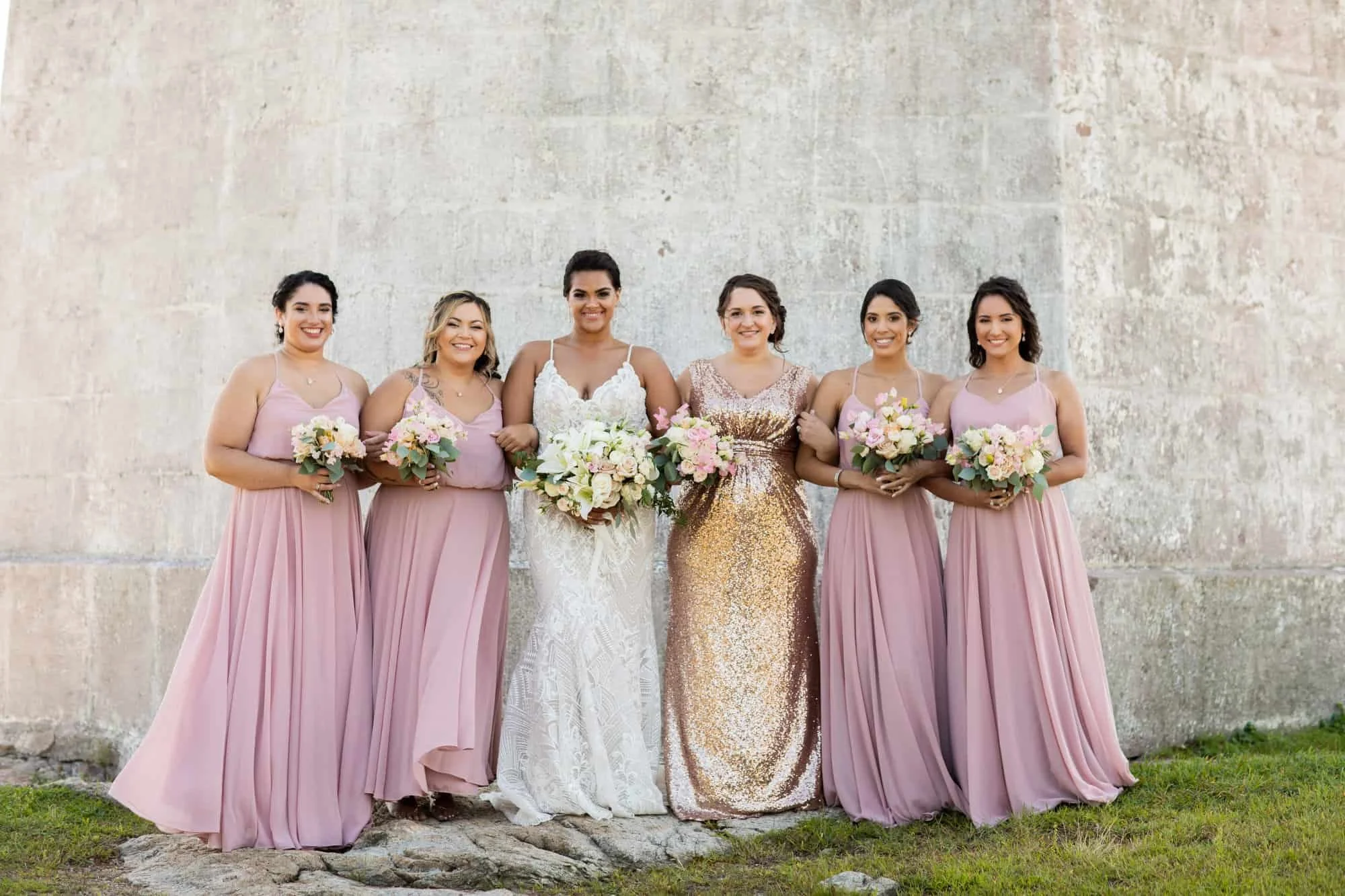Hand-tied bridesmaid bouquet of cream roses and blush lisianthus wrapped in blue ribbon
