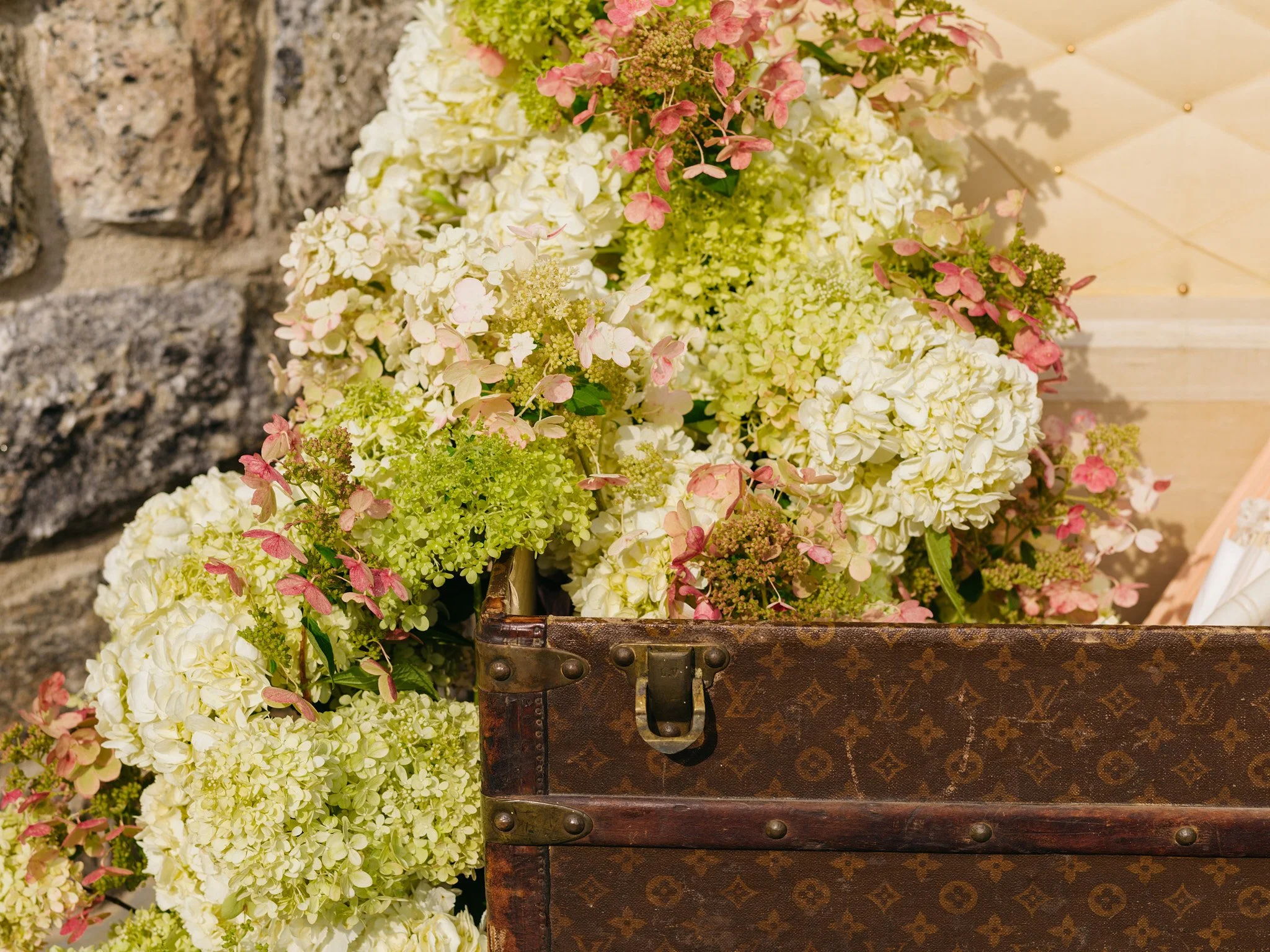 Detail shot of lace parasols and local hydrangea inside vintage trunk display