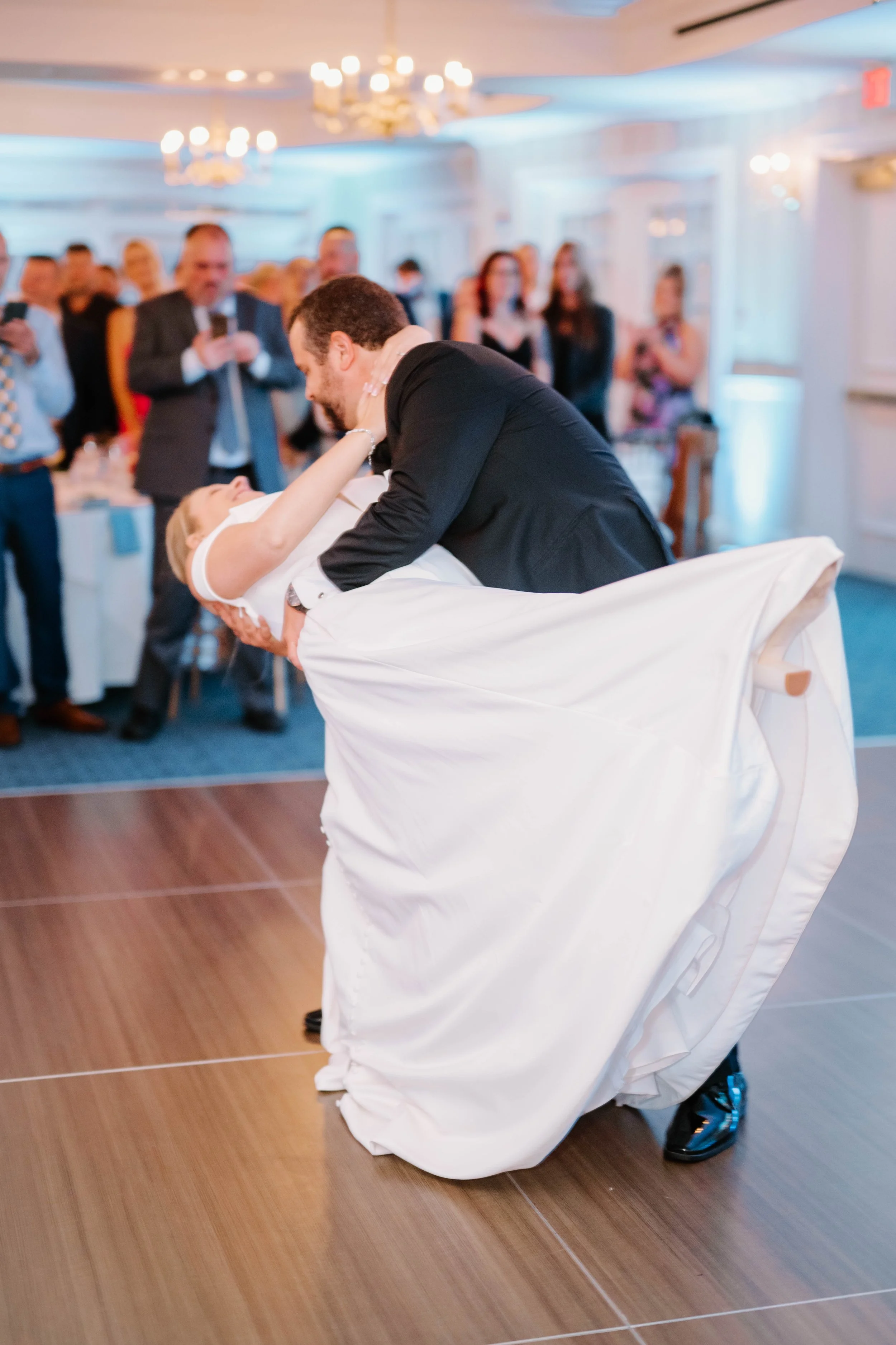 Nighttime ballroom photo with glowing candles and blue floral accents at Madison Beach Hotel