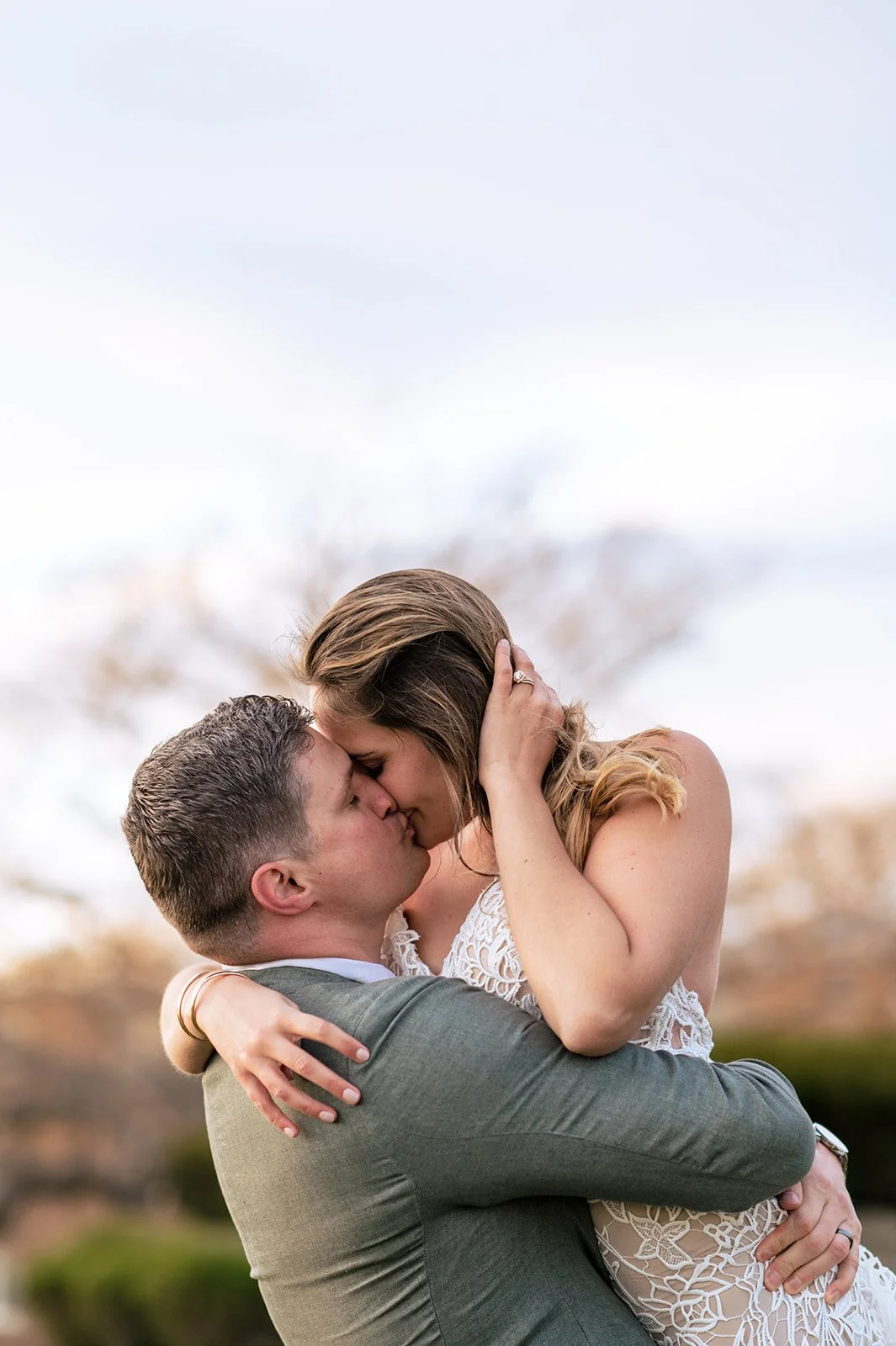 Bride in a slim vine-lace wedding gown with a low scoop back at golden hour on the grounds of Branford House