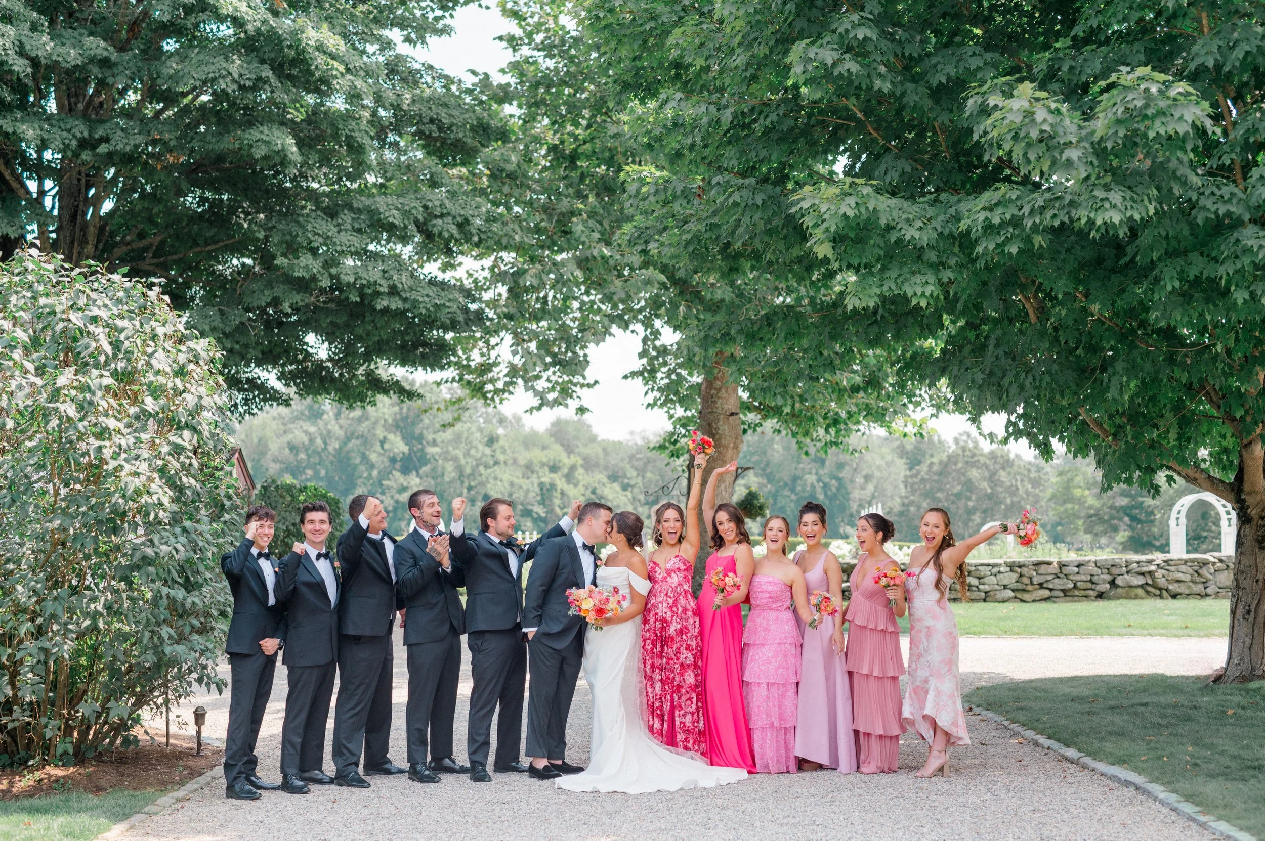 Wedding party style inspiration featuring modern suits and bright summer attire.