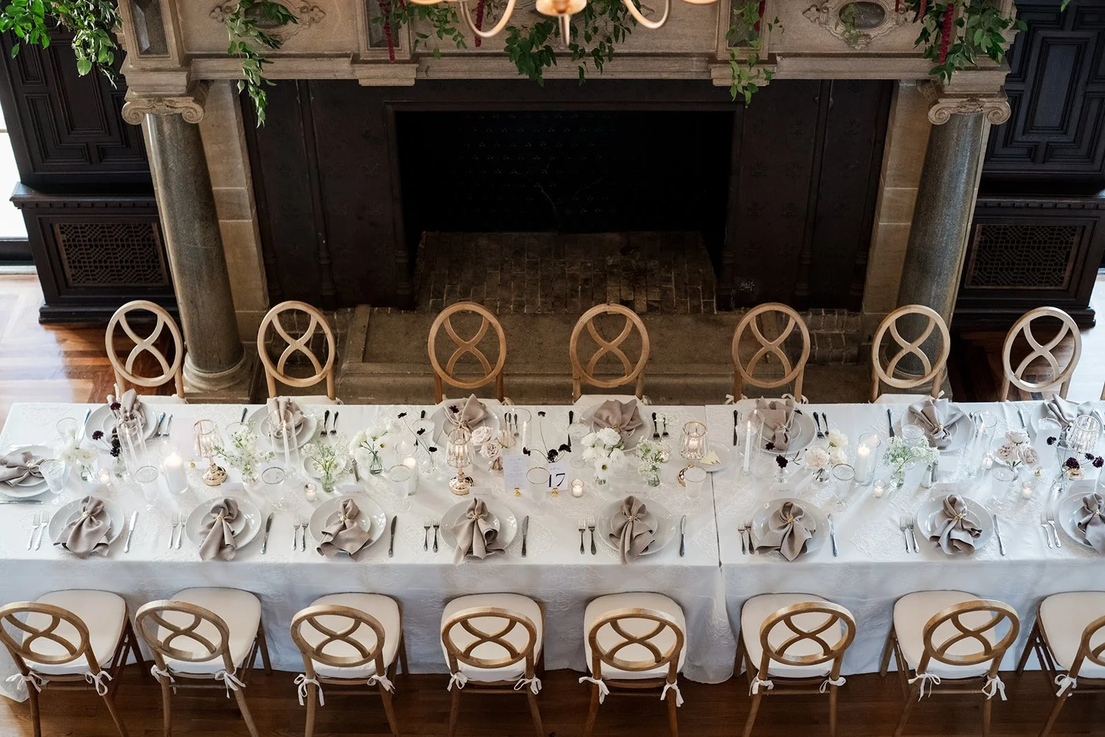 Soft white floral centerpiece paired with coastal neutrals for an elegant reception look.