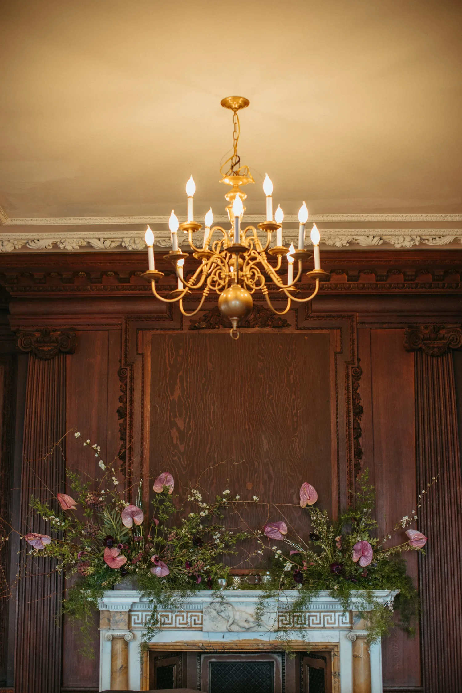 Dark romantic wedding mantle installation at Branford House with candles and moody florals