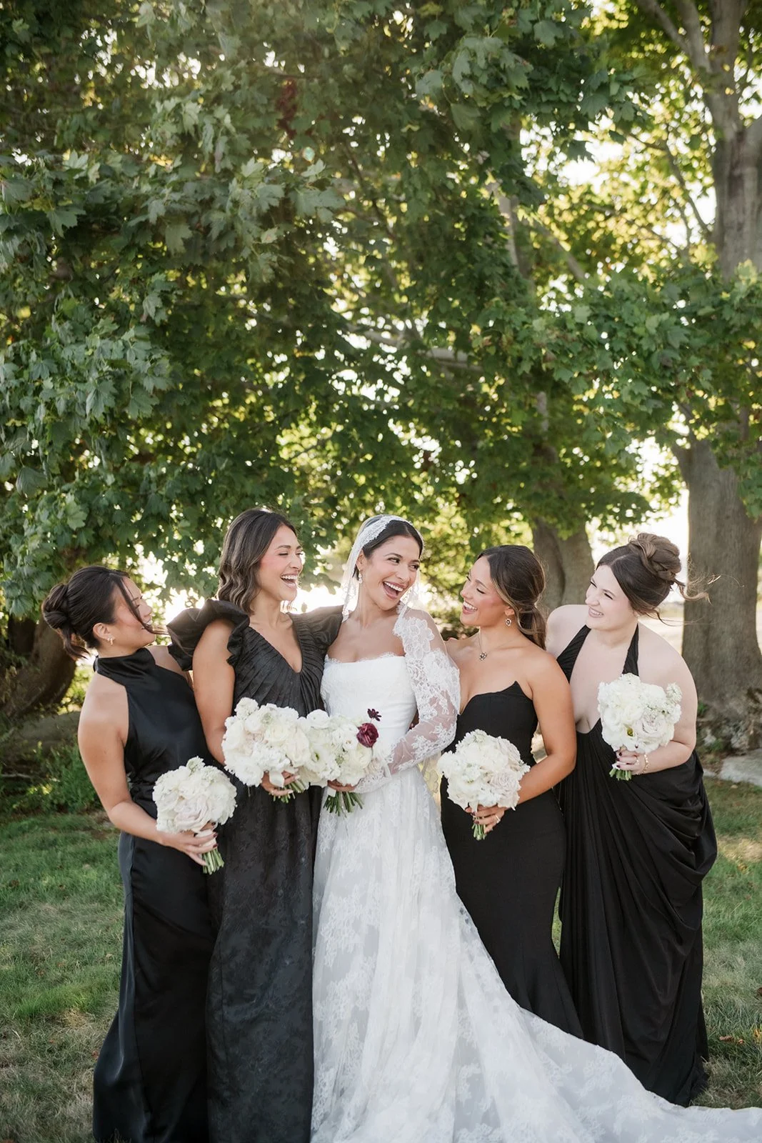 Editorial bridal bouquet featuring white blooms with dramatic plum accents.