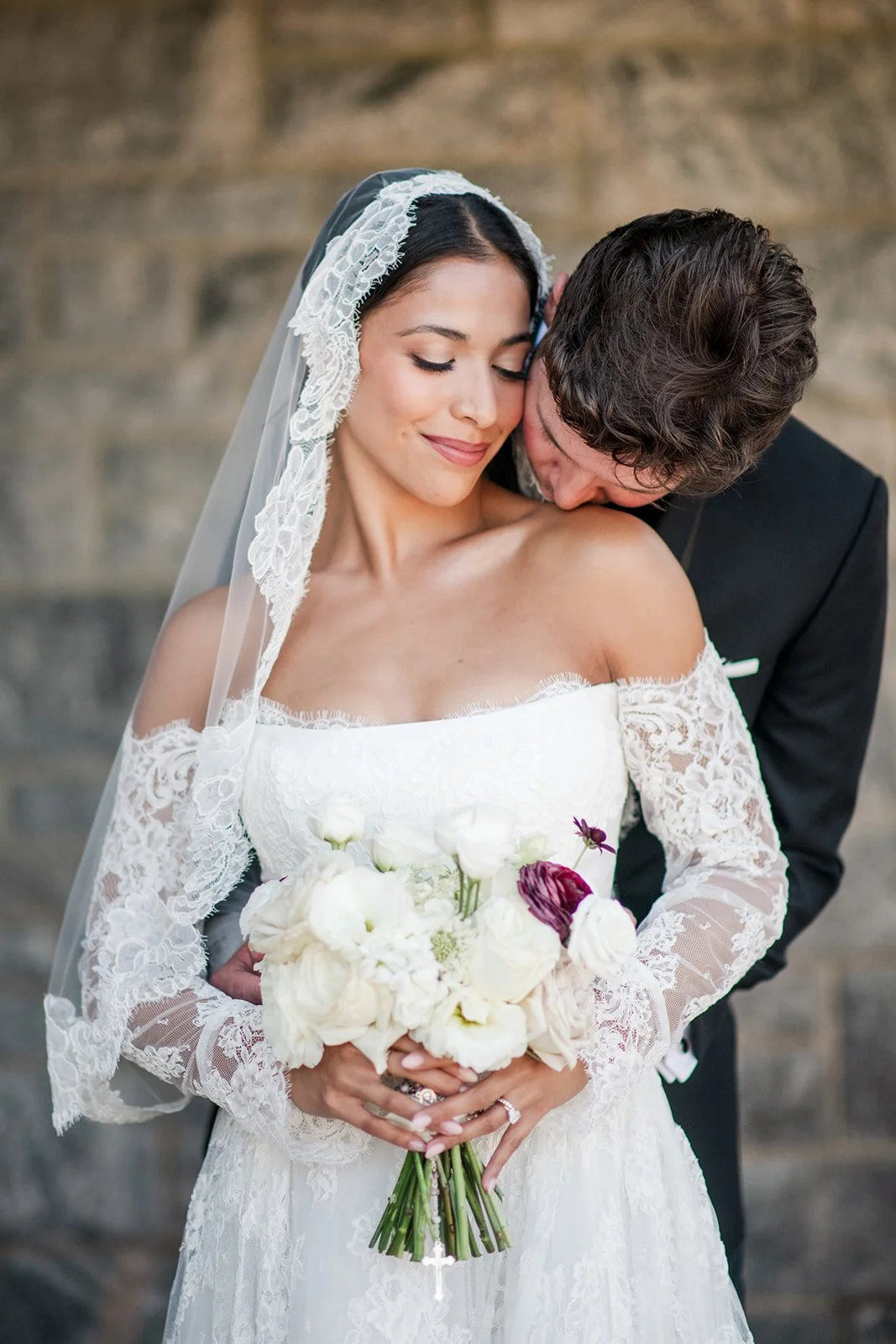 Textural garden-style bridal bouquet with layered white florals and deep plum tones.