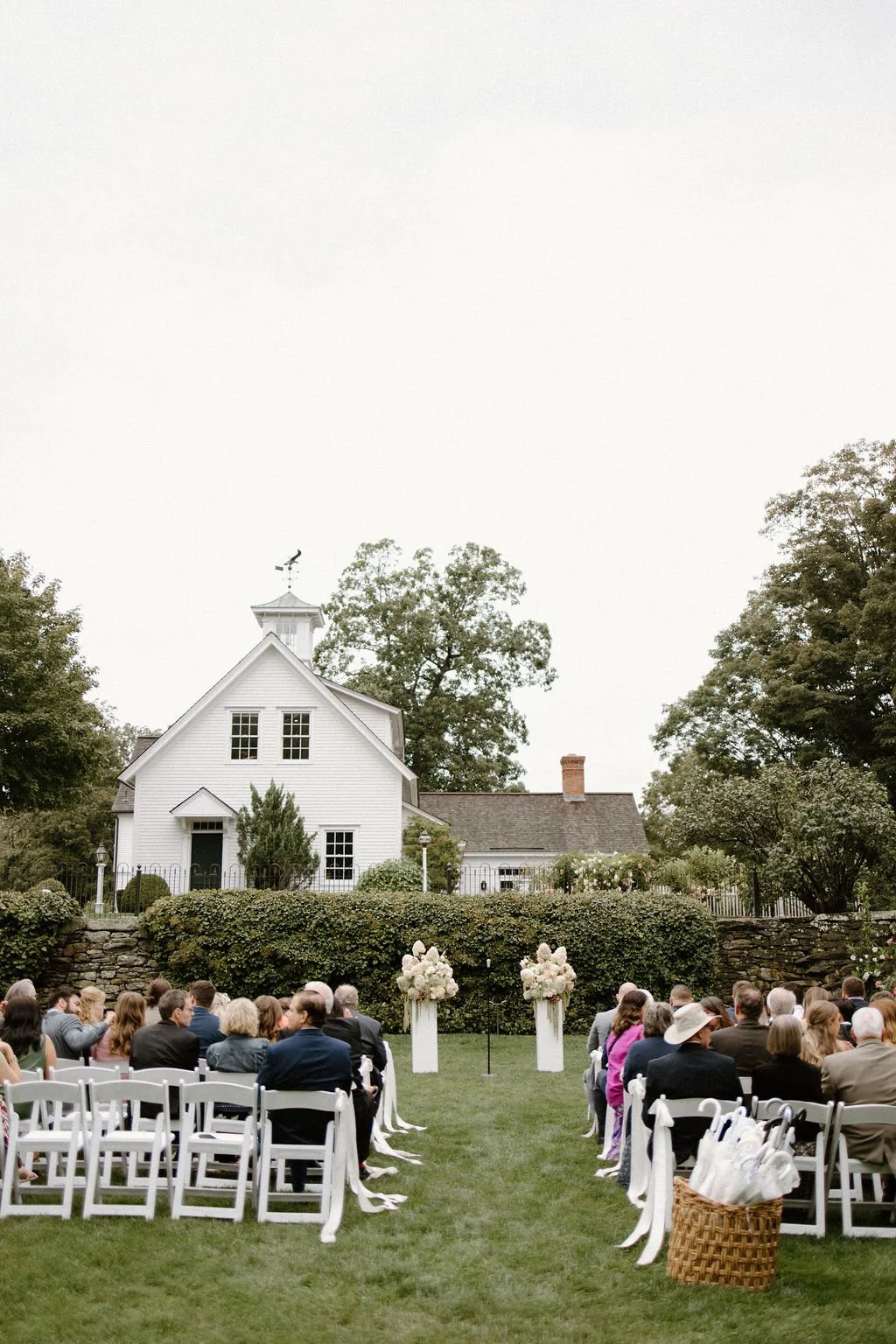 Wide view of guests gathered for an outdoor wedding ceremony at Smith Farm Gardens.