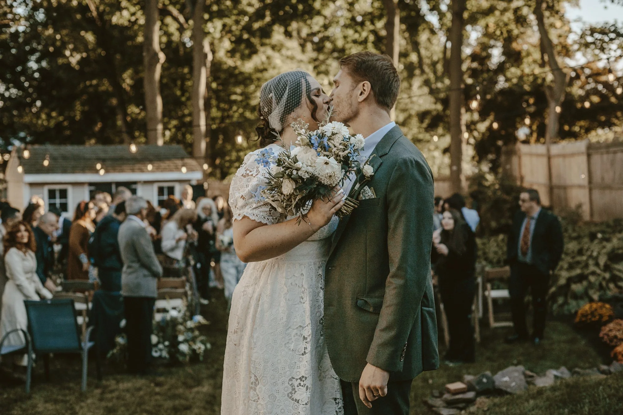 Lush bridal bouquet of white blossoms, soft blue delphinium, thistle and eucalyptus by a Connecticut wedding florist