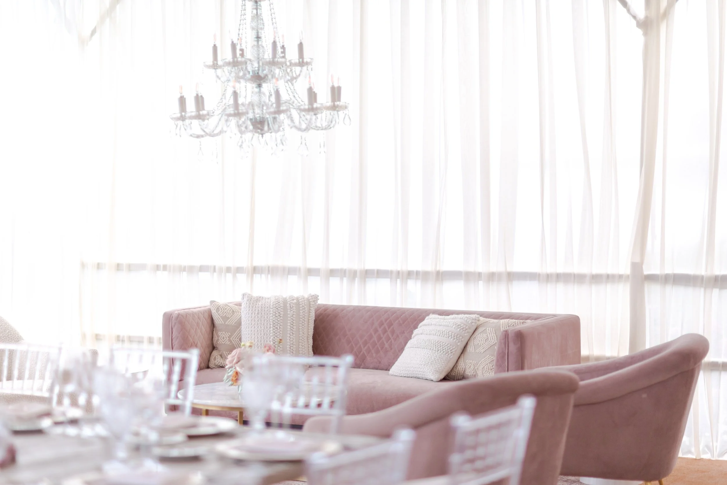 Lounge seating area at a baby shower under a tent