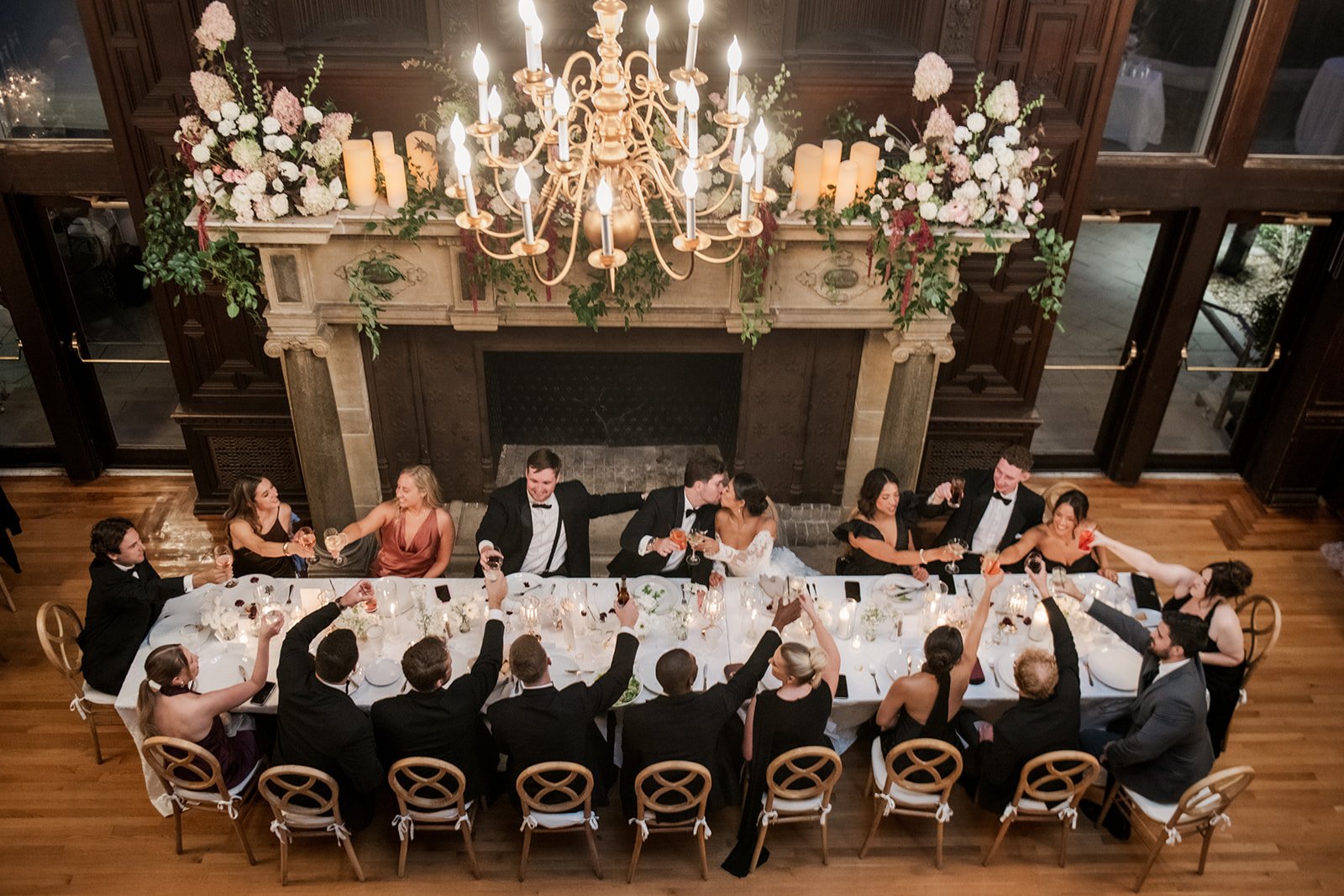 Editorial wedding atmosphere at Branford House with candlelight, layered textures, and architectural elegance.