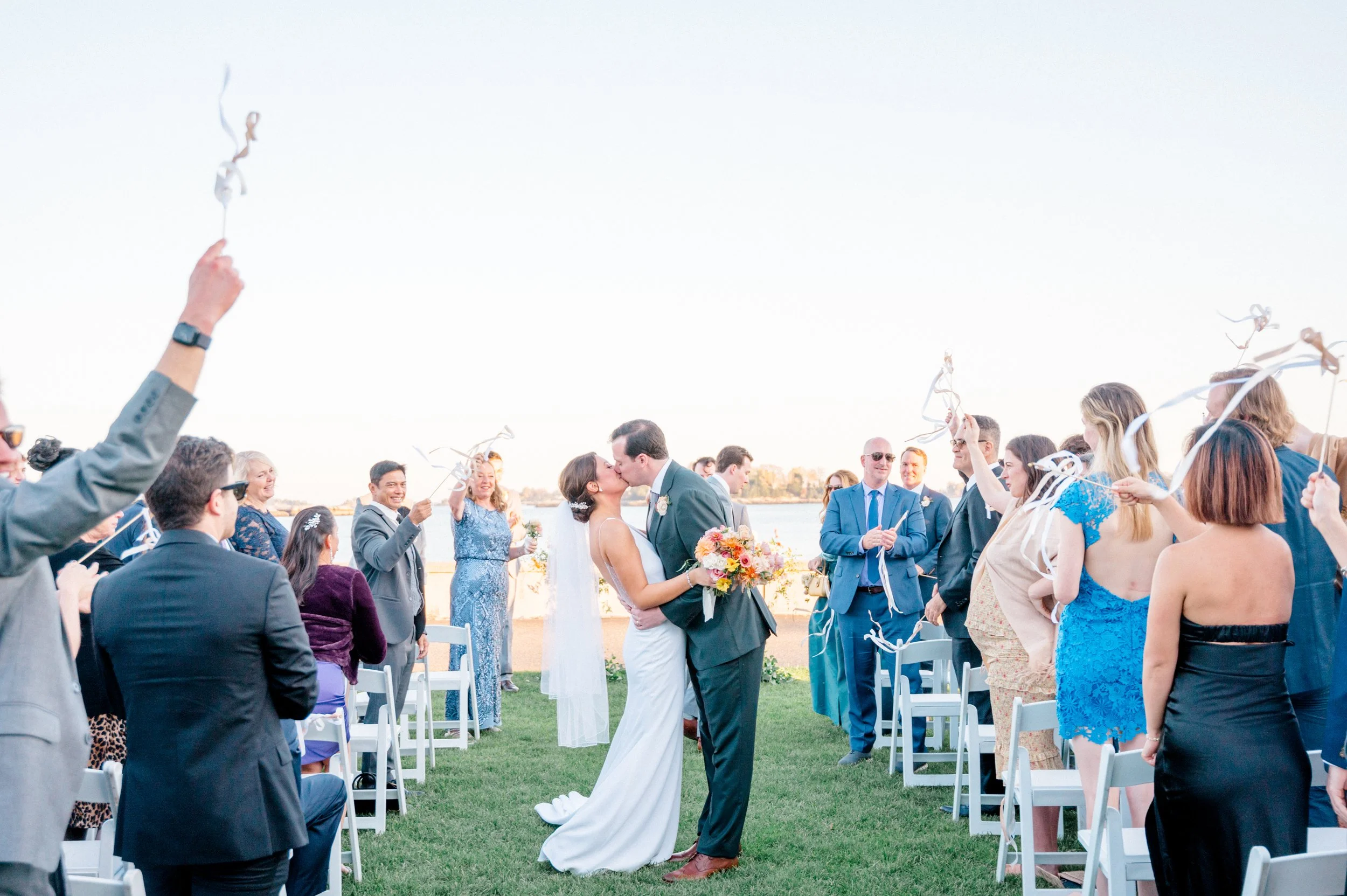 Bride and groom exchanging vows facing the Sound at Pine Orchard Yacht Club.