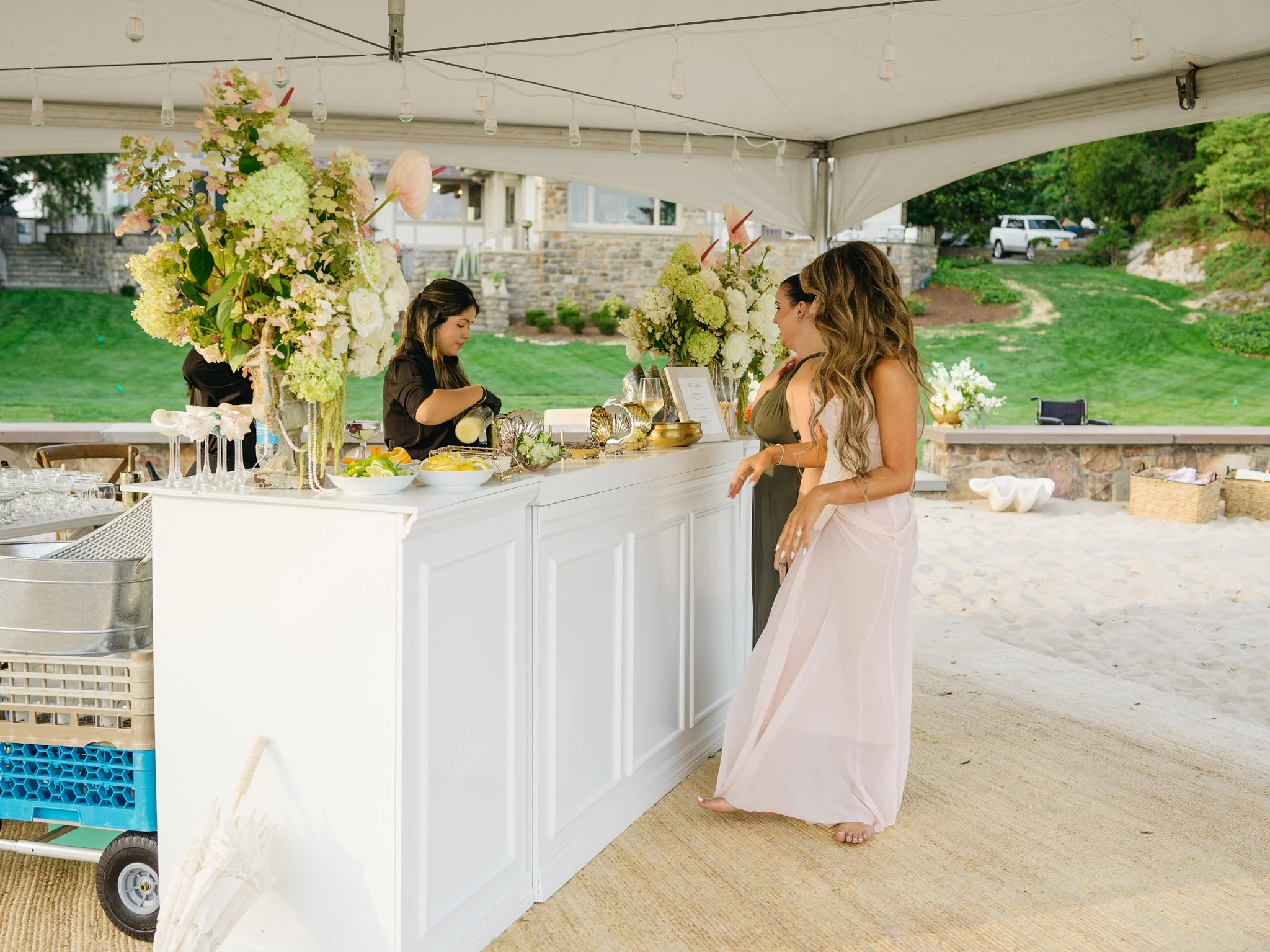 Full bar setup with sculptural floral arrangements and coastal styling, Fairfield County private residence bridal shower