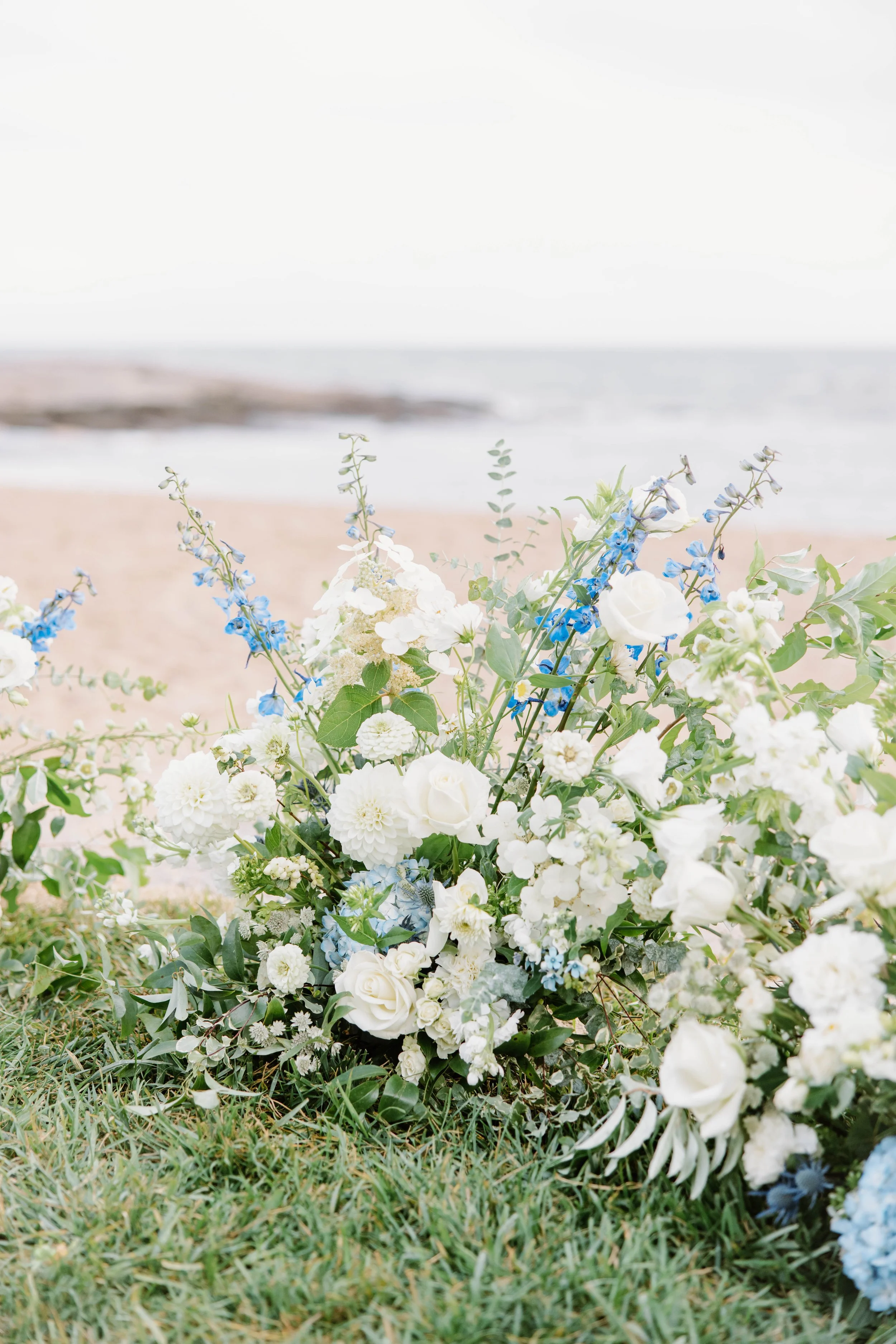 Oceanfront view of Madison Beach Hotel in Madison CT before wedding ceremony with coastal breeze and blue sky.
