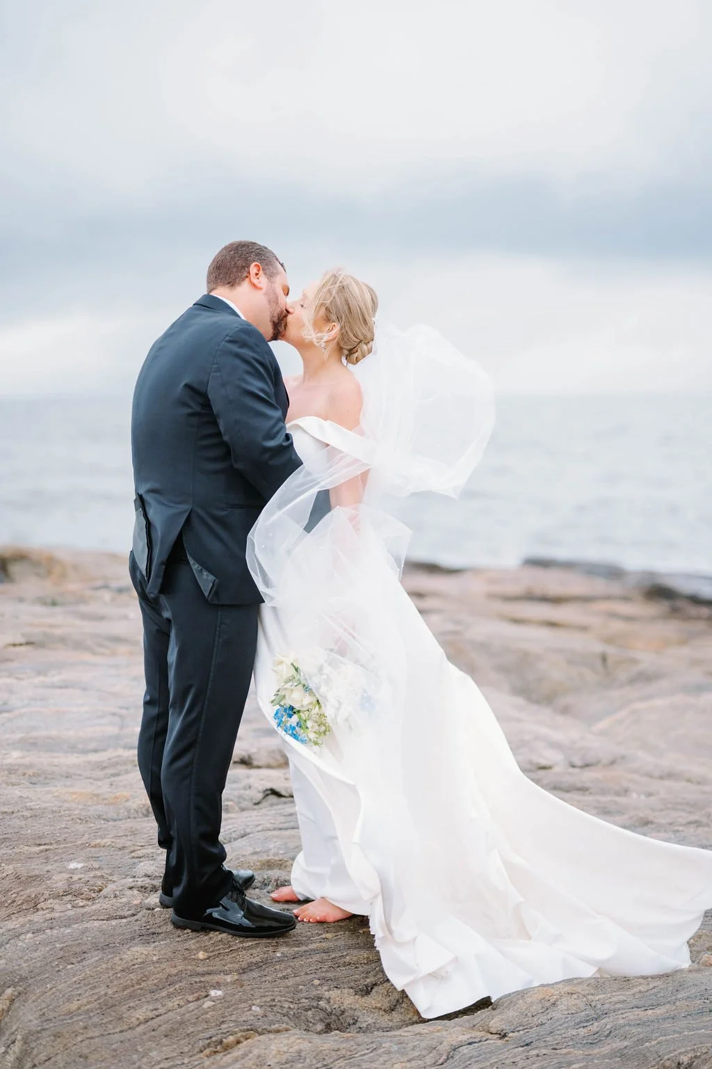 Waterfront ceremony overlooking Long Island Sound with romantic coastal florals.
