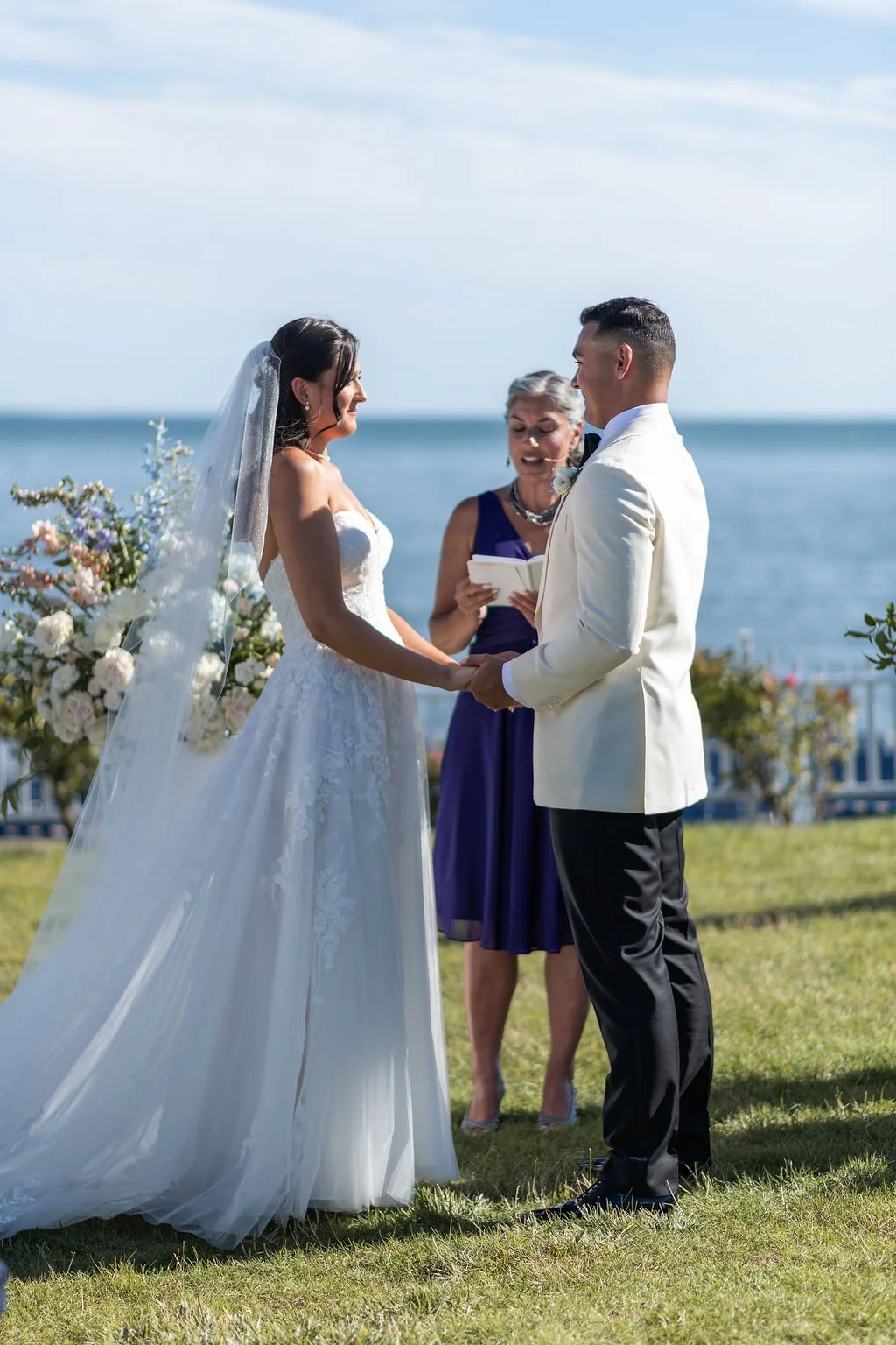 Bride and groom exchanging vows at an outdoor waterfront ceremony at Water's Edge Resort and Spa Connecticut
