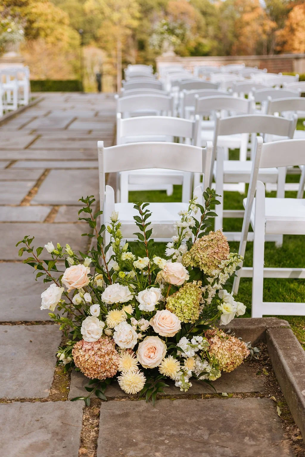 Low ceremony entrance arrangements with branches and neutral blooms at Waveny House