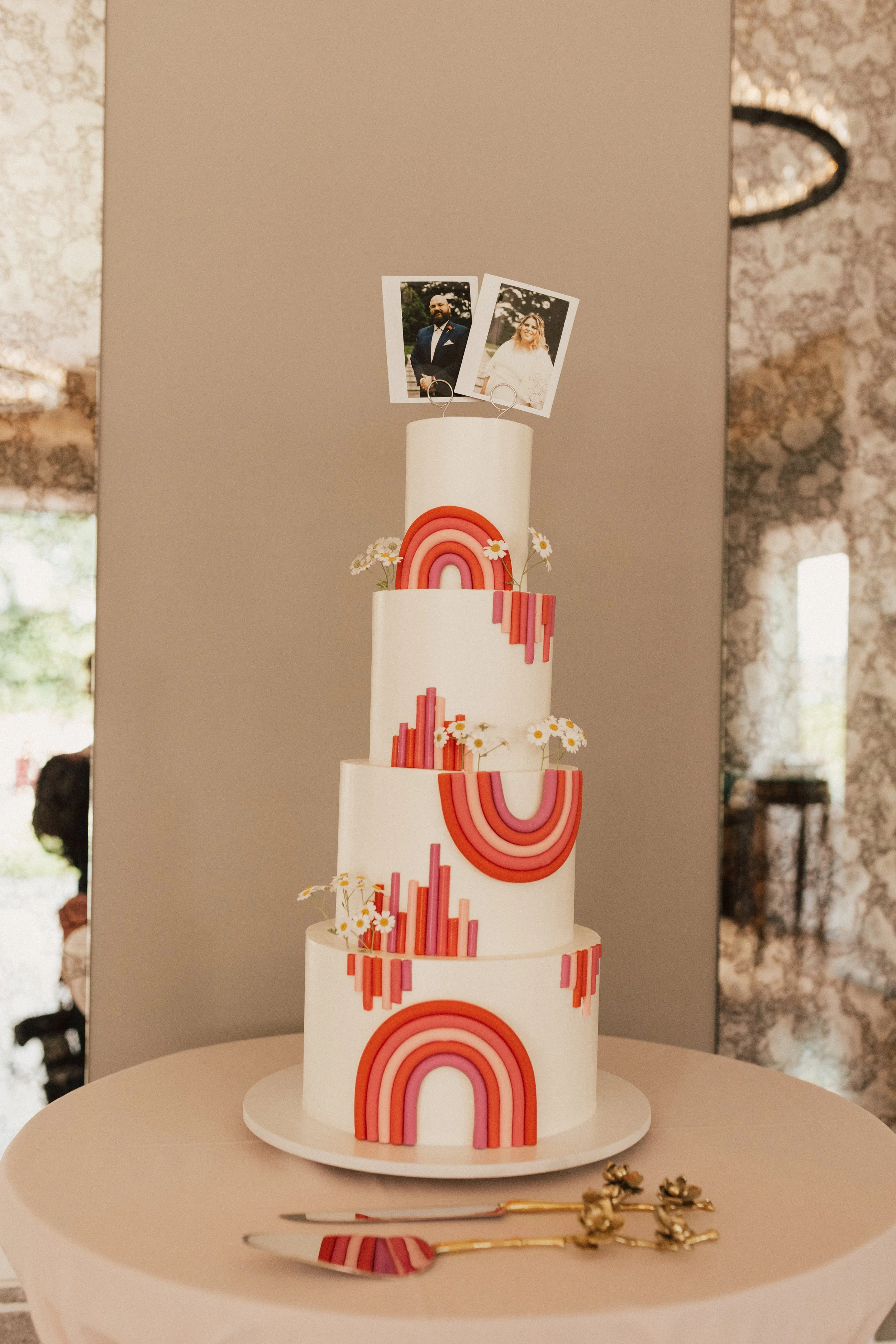 Rainbow wedding cake adding playful color to a bold, modern wedding reception.