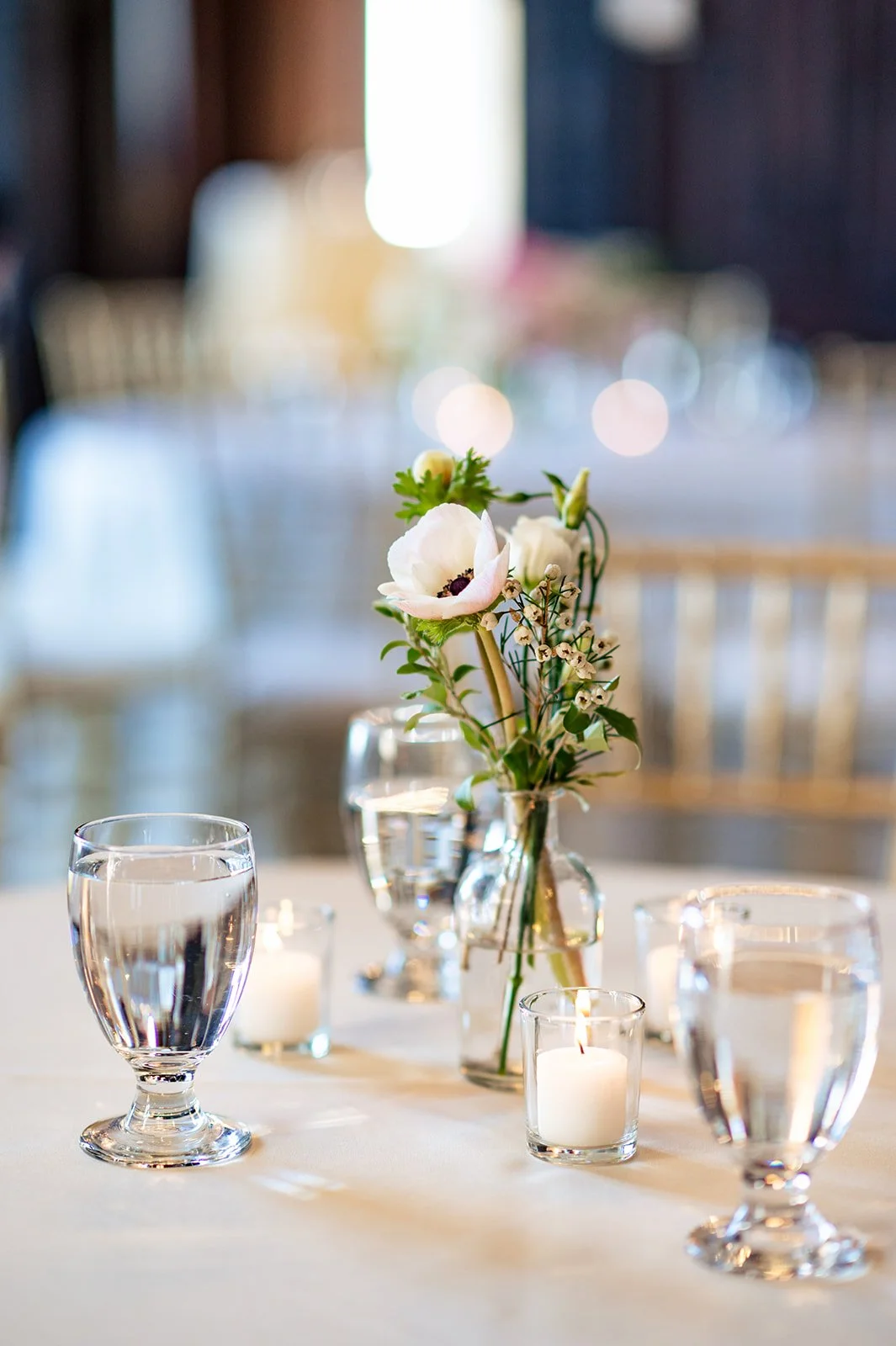 White and blush bud vases scattered through cocktail hour at a Branford House wedding