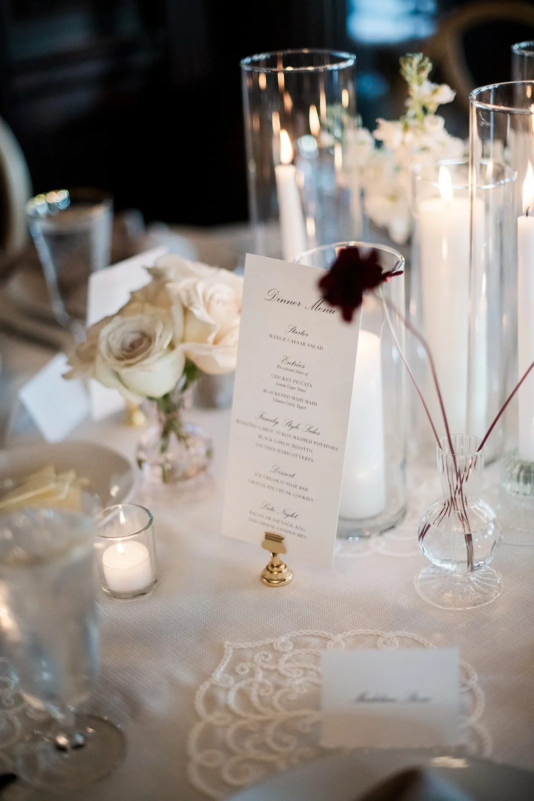 Wedding tablescape details with bud vases, tapers, and soft neutral linens.