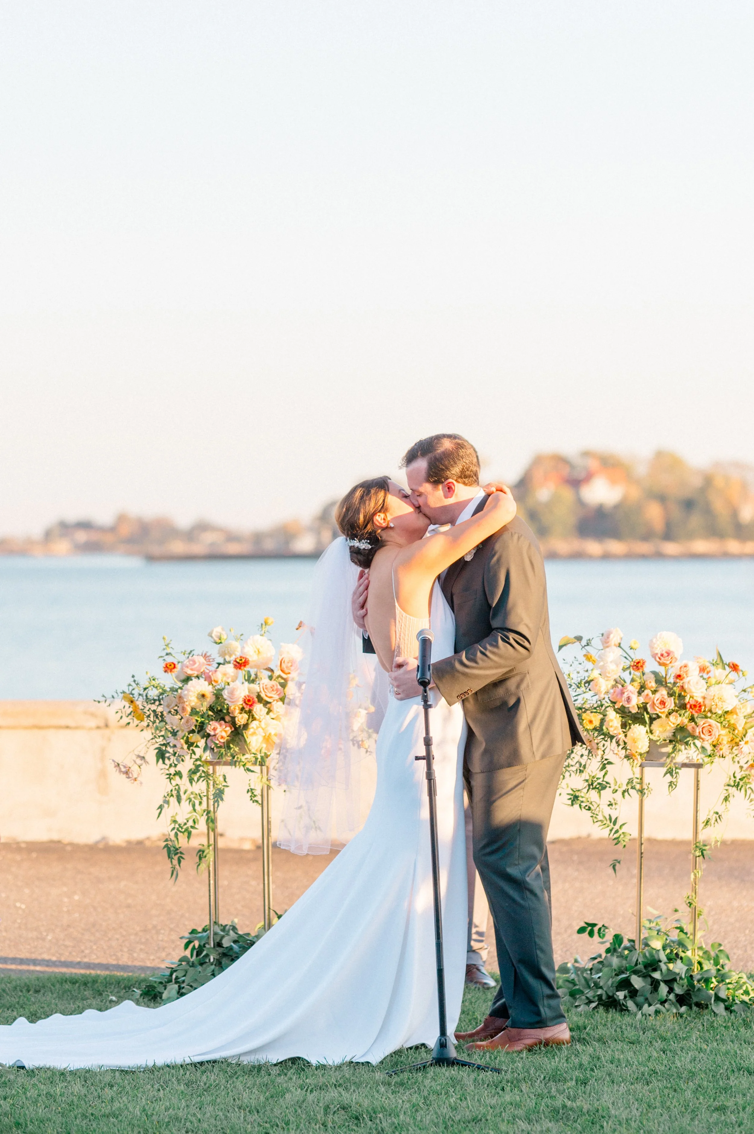 Bride and groom exchanging vows facing the Sound at Pine Orchard Yacht Club.