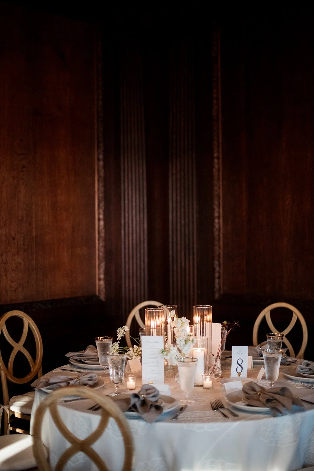 Branford House tablescape featuring textured florals and tall taper candles.