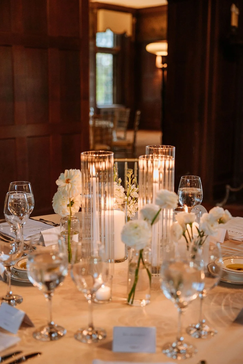 Alternating wedding tables with bud vases tapers and pillar candles