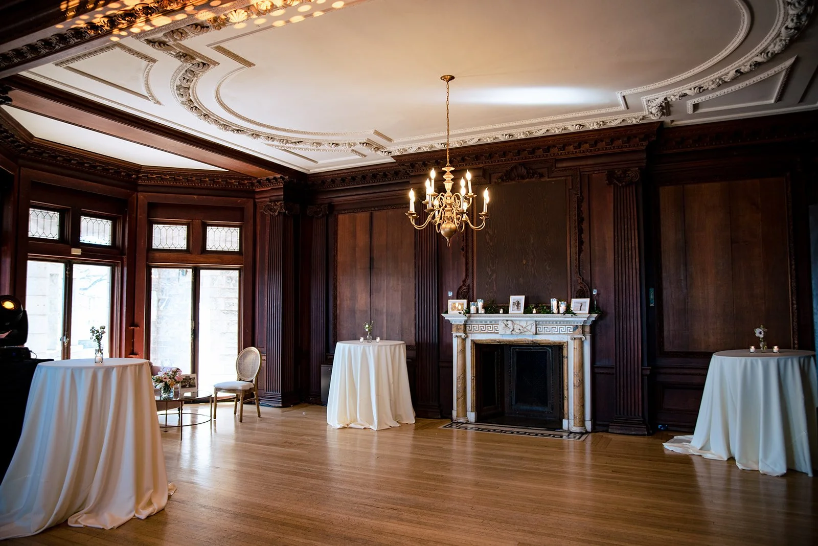 High-top table in the Branford House West Room with a simple glass bud vase and votive candles