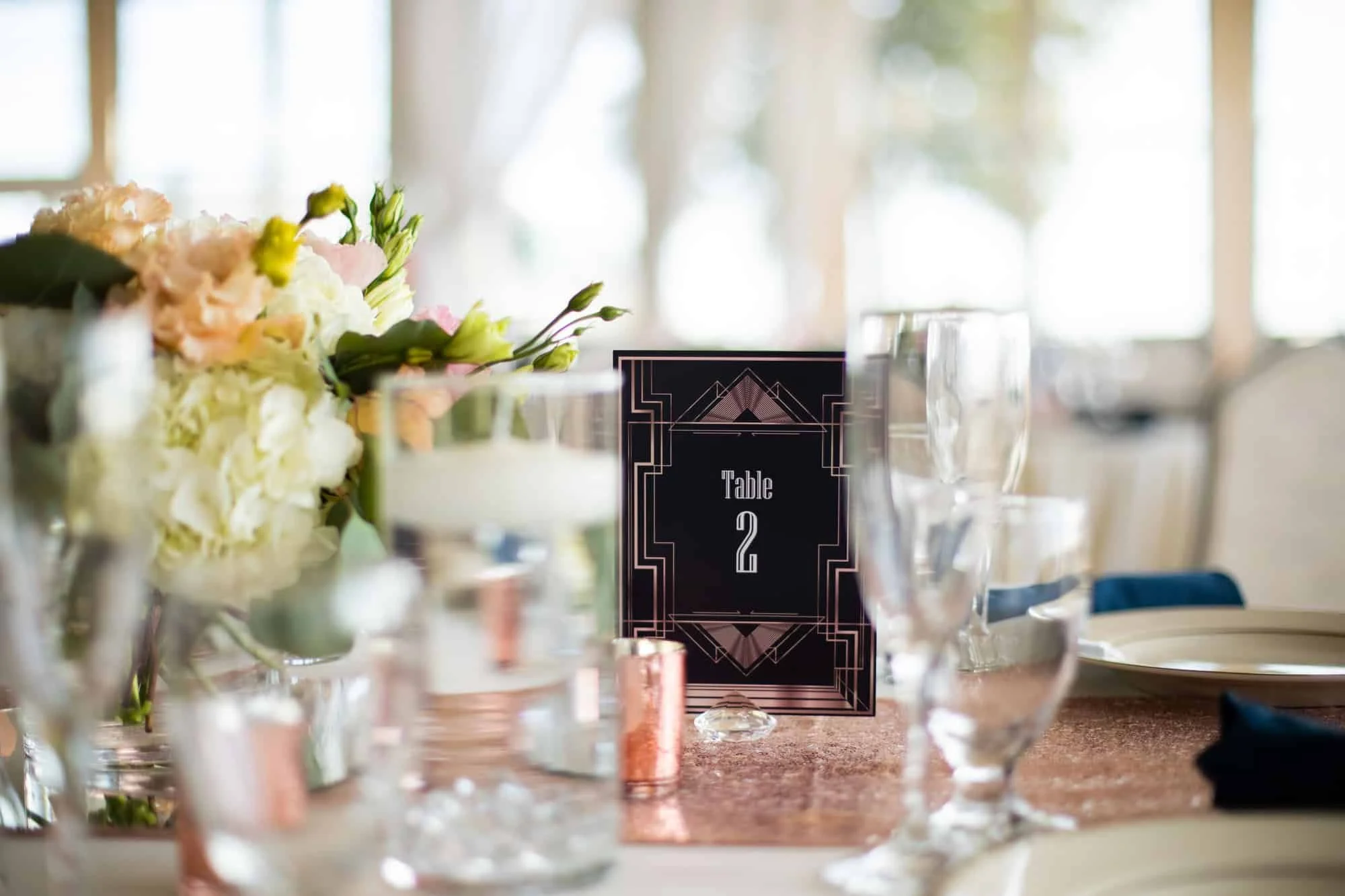 White hydrangea centerpiece in clear glass with candlelight at a carousel wedding reception in New Haven, CT
