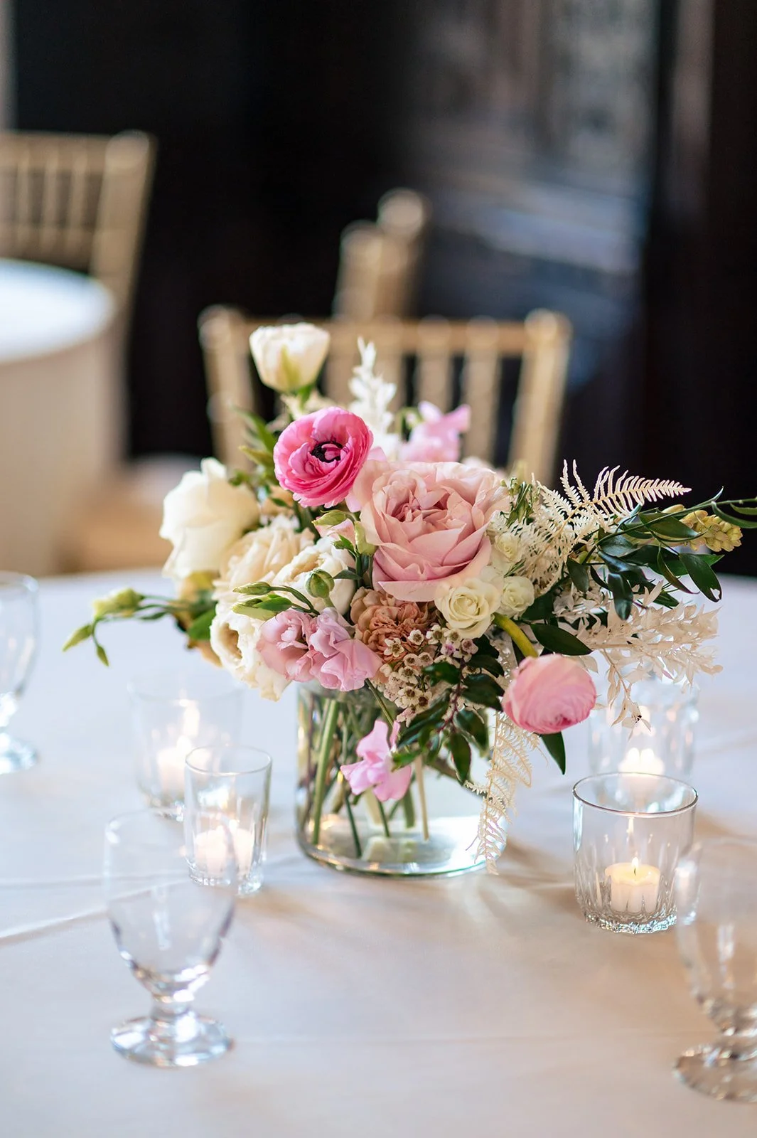 Close-up of a blush-and-white wedding centerpiece with dried white fern and ruscus adding wispy texture, by a Connecticut wedding florist