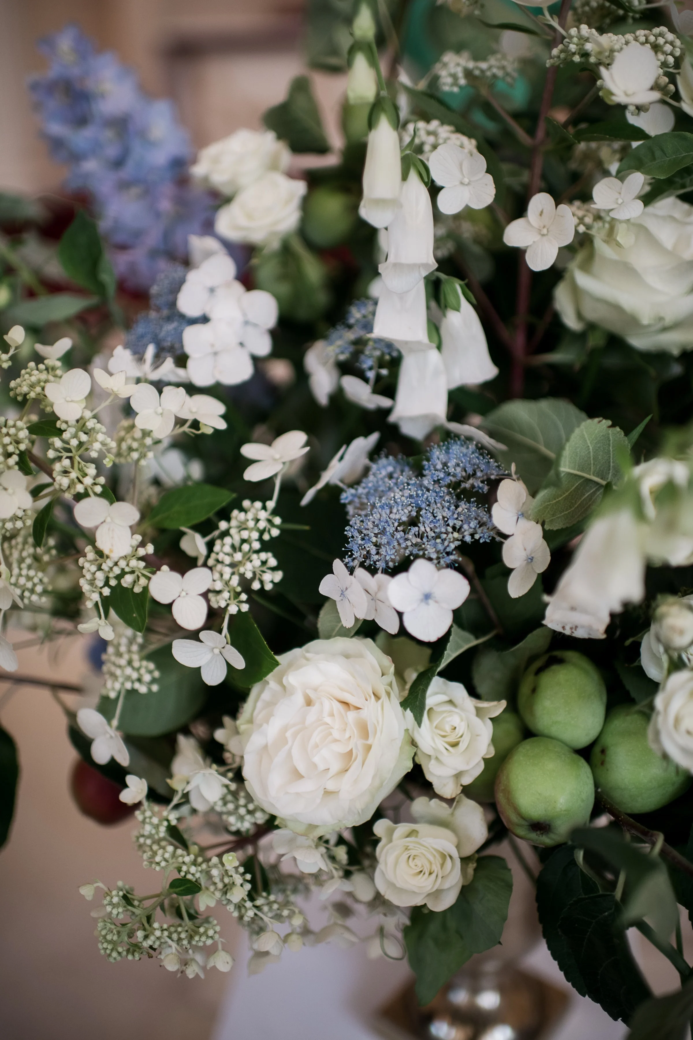 Church ceremony with large white floral arrangements and apple branches