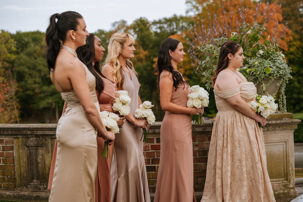 Bridal party portrait with mixed satin champagne dresses in garden ceremony space at Waveny House Connecticut