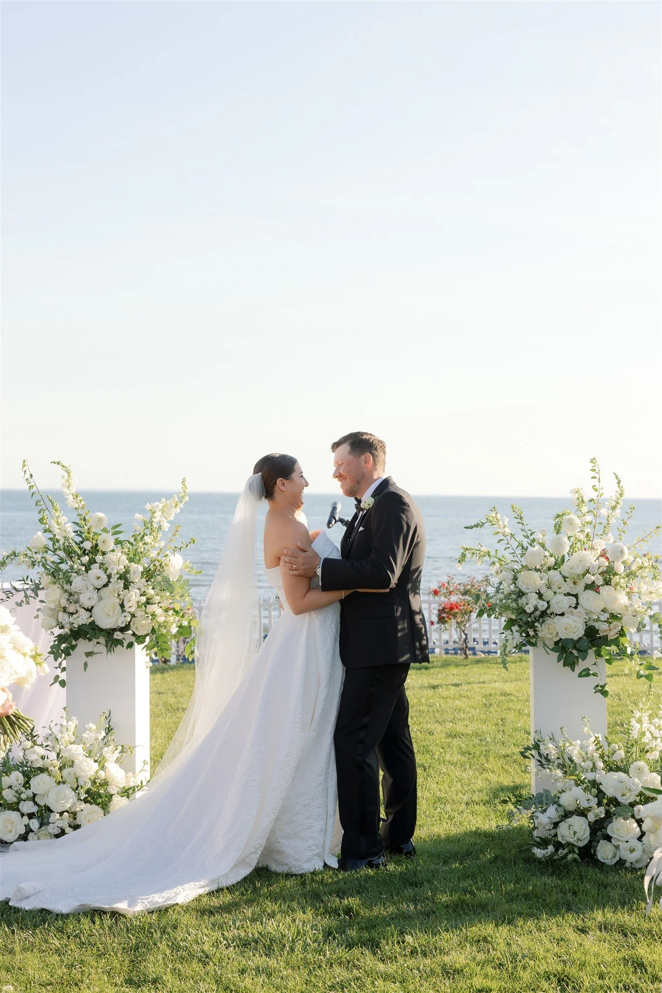 Sculptural white columns framing a hazy blue shoreline.