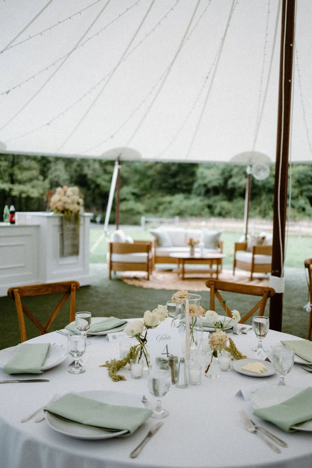 Neutral wedding reception tablescape featuring soft floral arrangements and elegant place settings.
