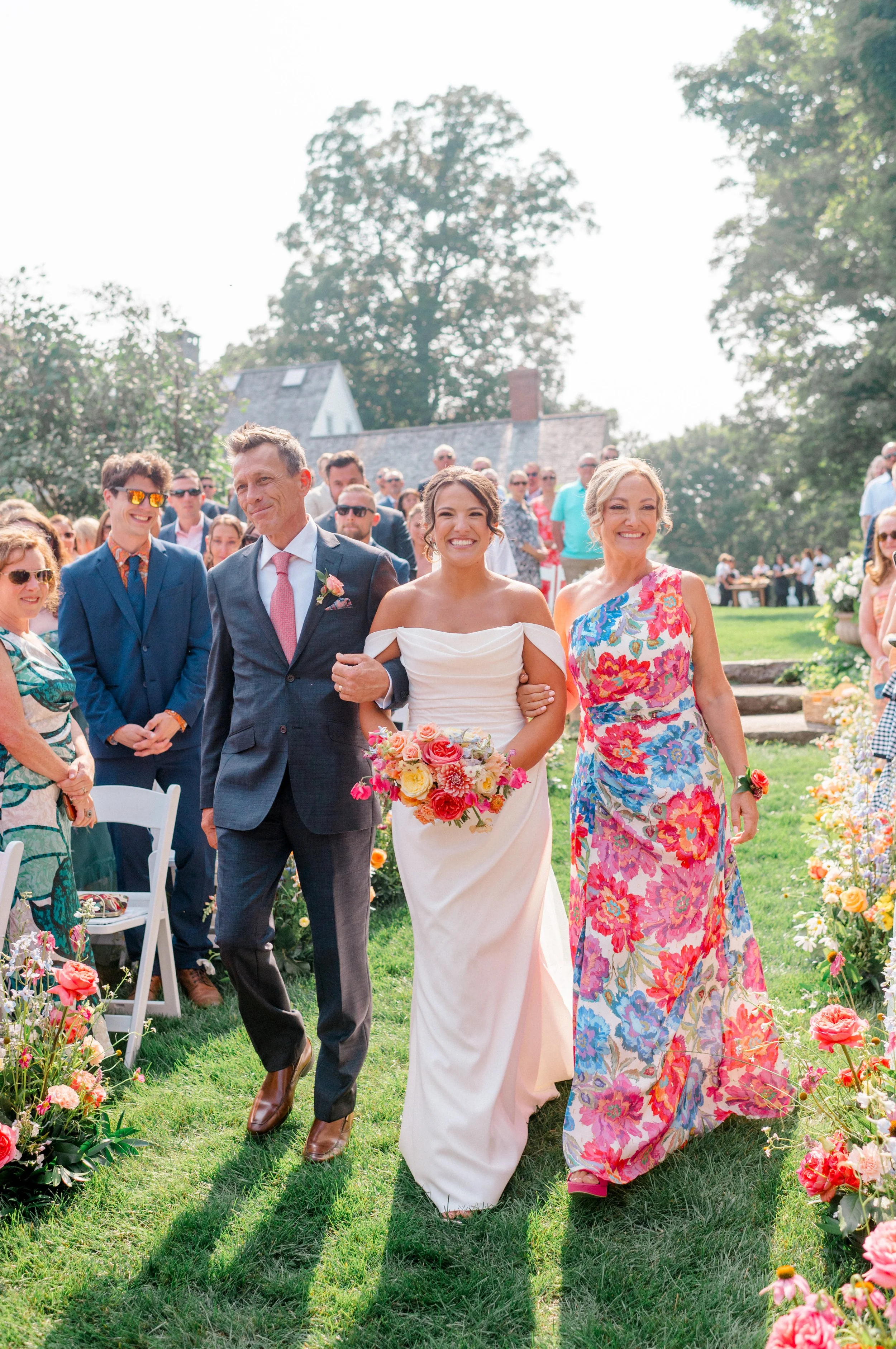 Bright ceremony florals featuring dahlias, zinnias, sweet pea, and local greenery.