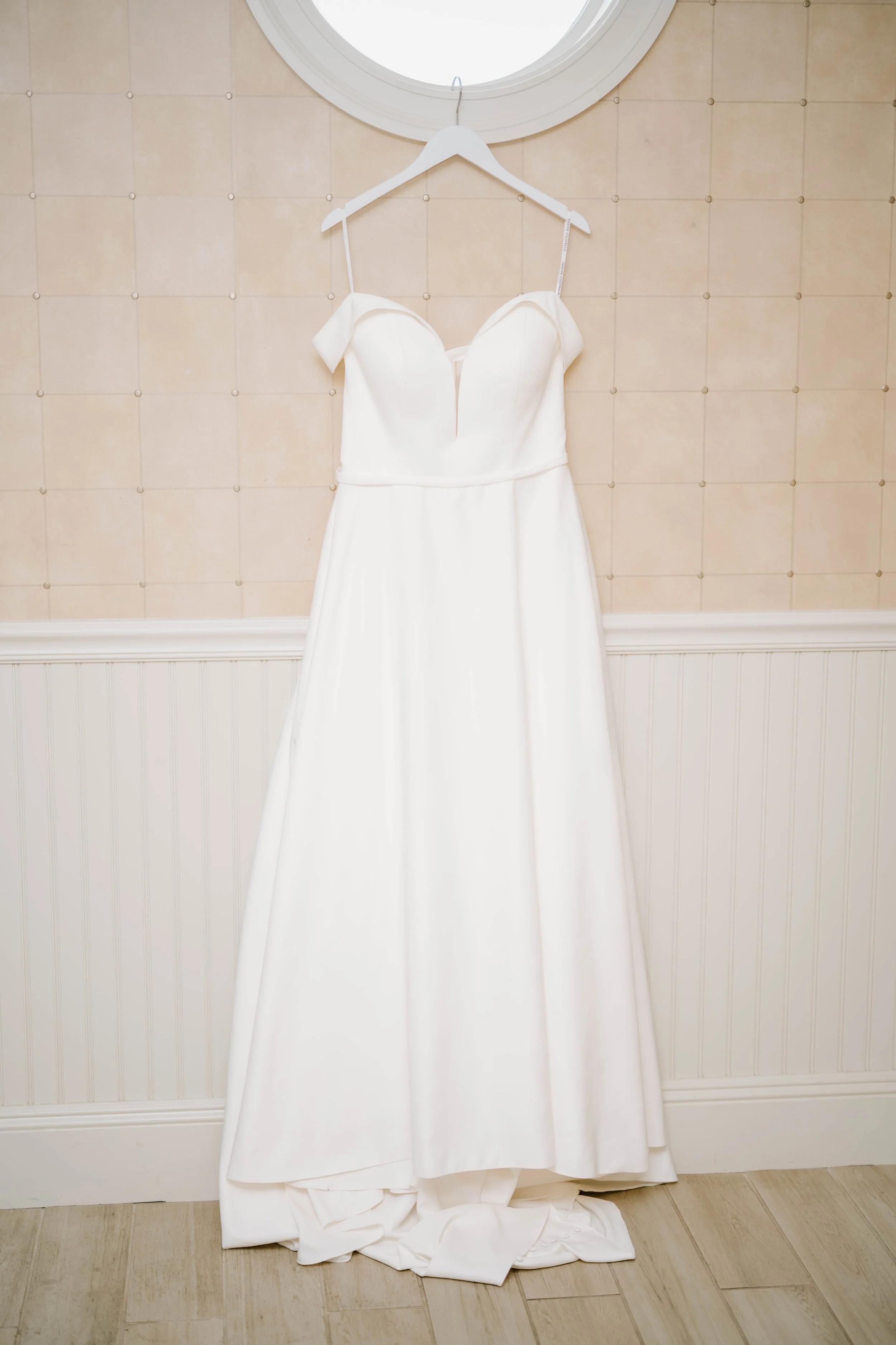 Bride in off-the-shoulder A-line gown at seaside Madison Beach Hotel wedding captured by Deirdre Volk Photography.