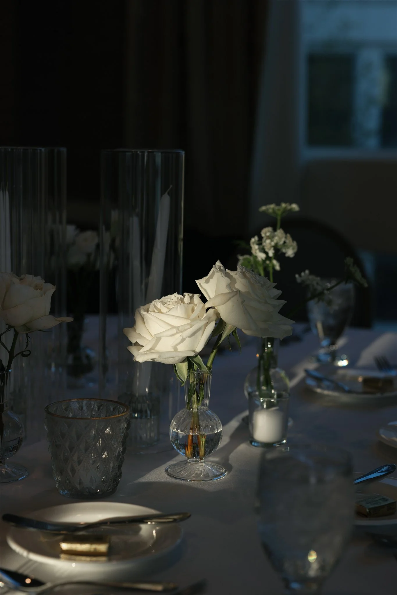 Glass hurricanes and soft whites creating an evening glow.