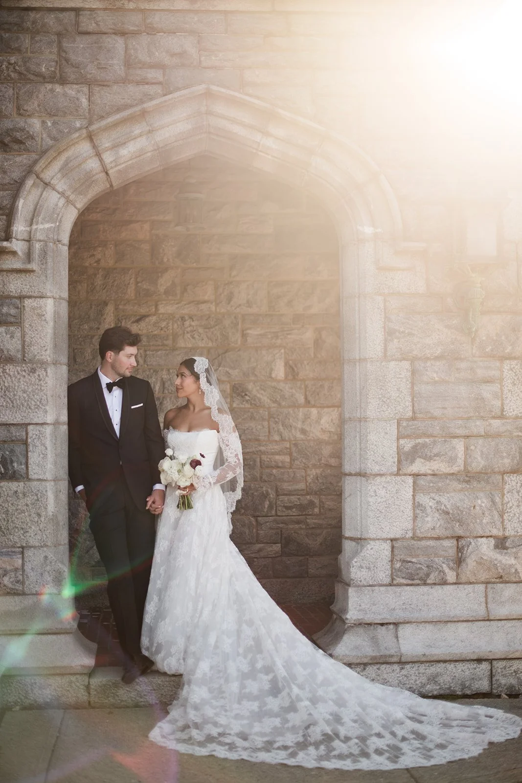 Architectural bridal portrait at Branford House featuring modern wedding florals and historic stone details