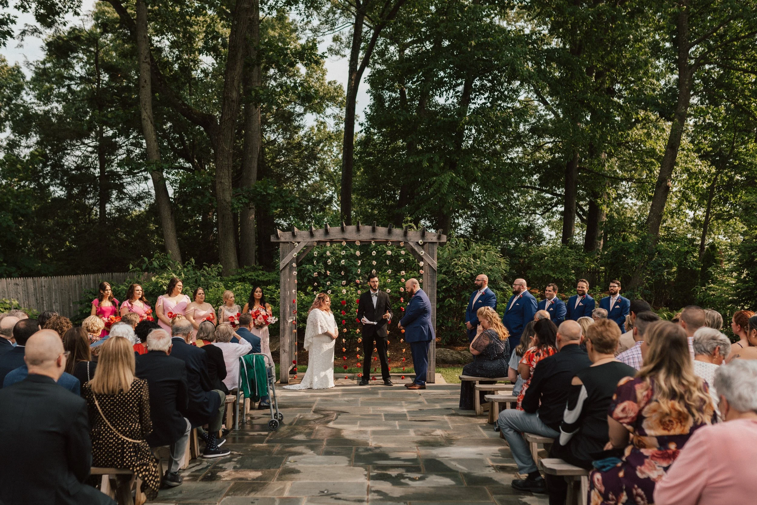 Colorful wedding ceremony in Connecticut with sculptural floral backdrop and modern design.