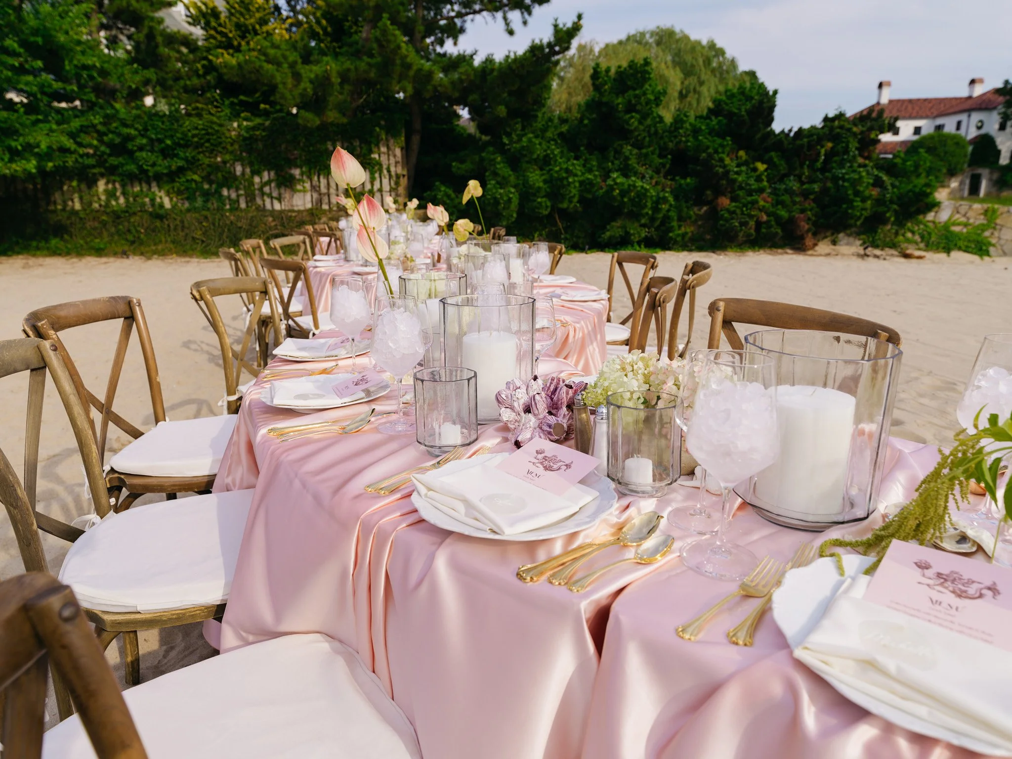 Wide shot of oceanfront tablescape at golden hour, coastal Connecticut wedding shower design