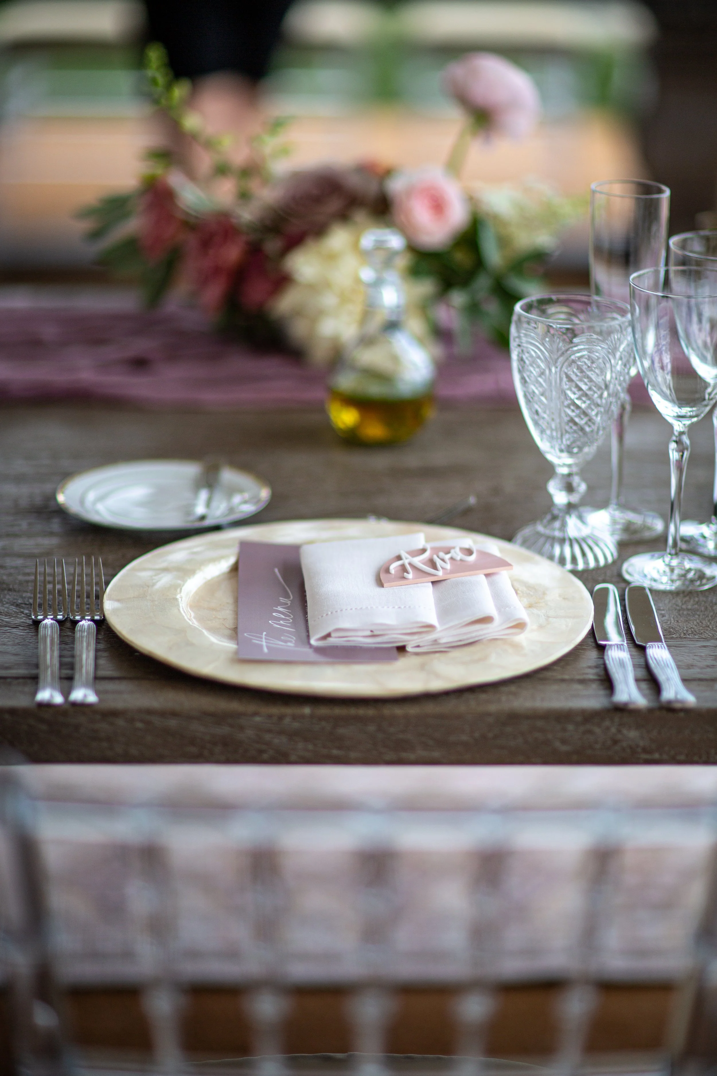 Shell chargers and glassware on a baby shower table