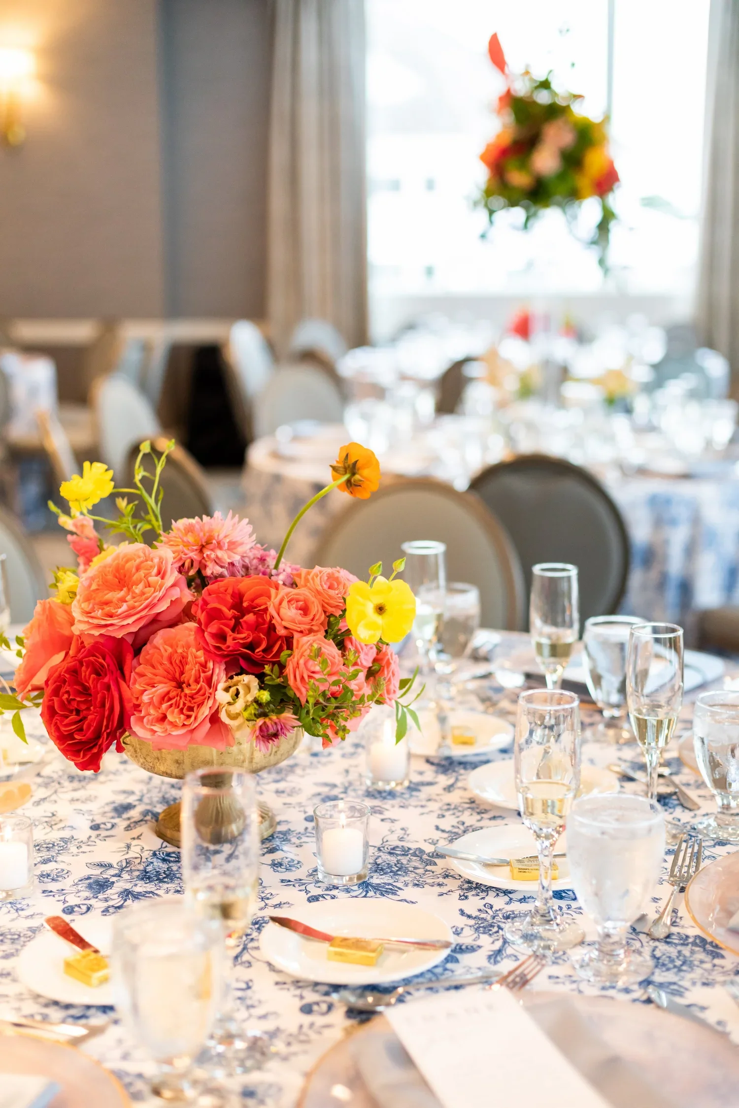Vibrant low centerpiece filled with lush blossoms for classic First Blush centerpiece at Waters Edge in CT