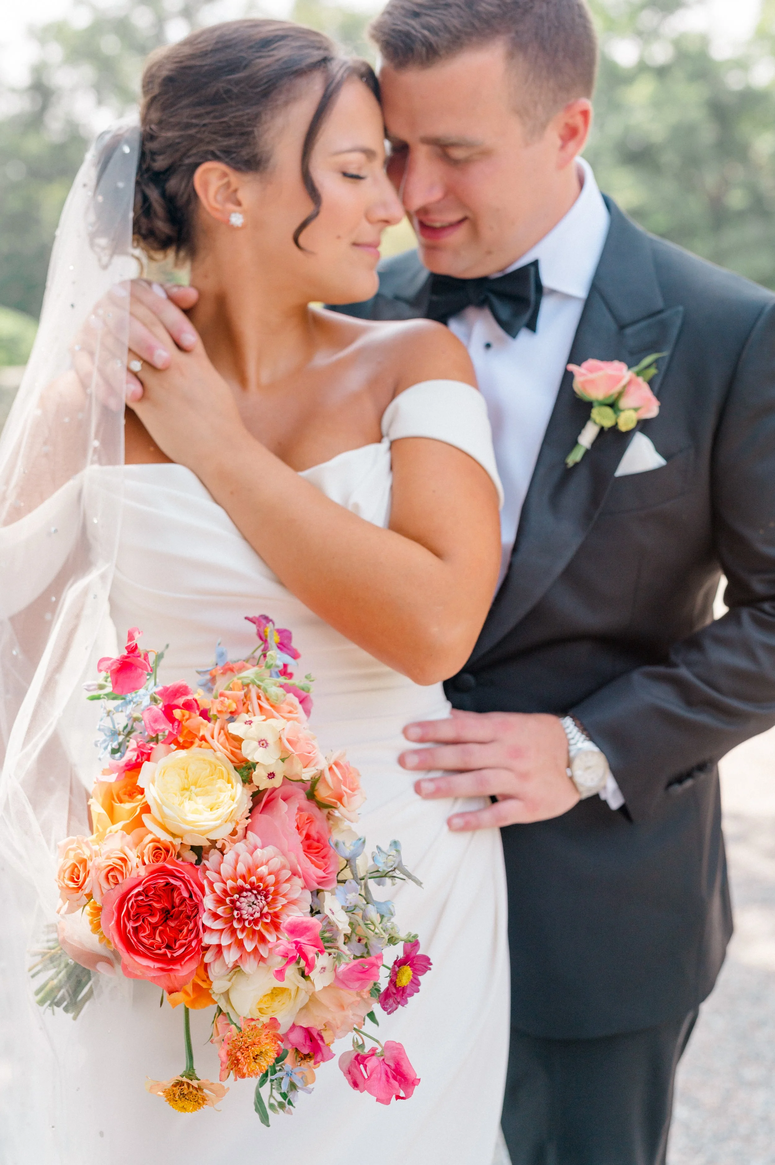 Bride holding vibrant garden bouquet designed by Connecticut florist First Blush