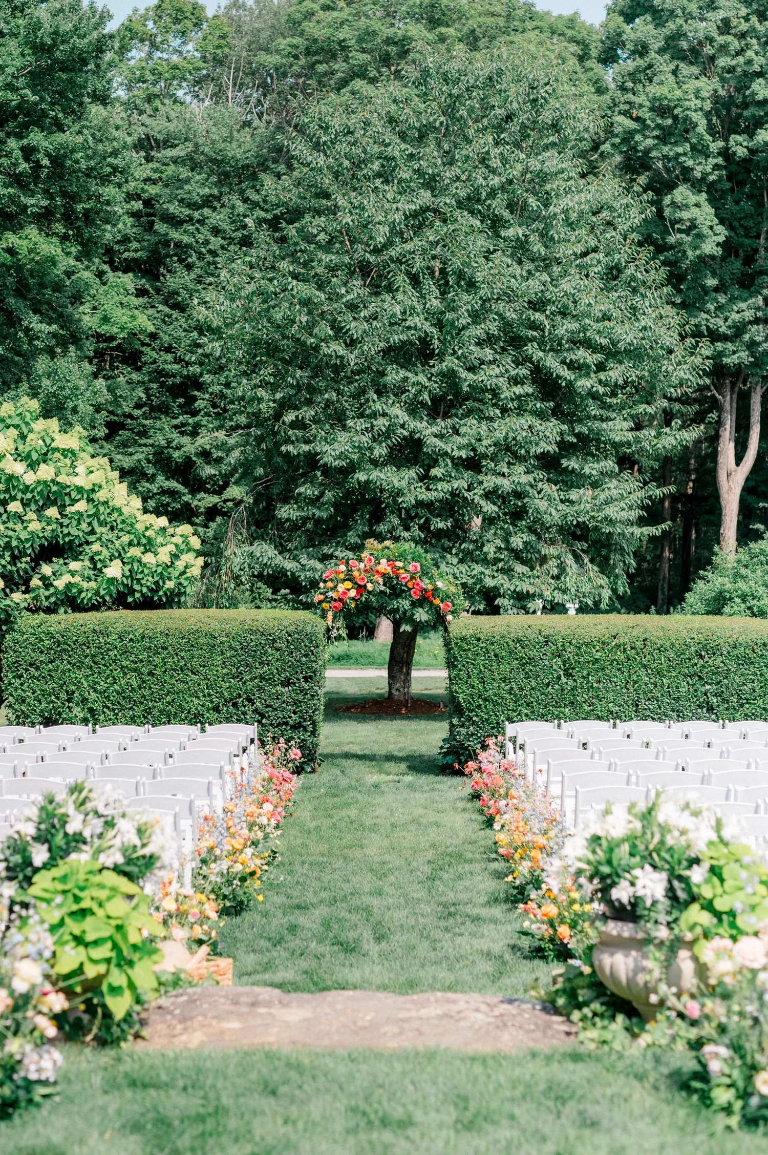 Garden wedding ceremony arch at Smith Farm Gardens styled with natural greenery and florals
