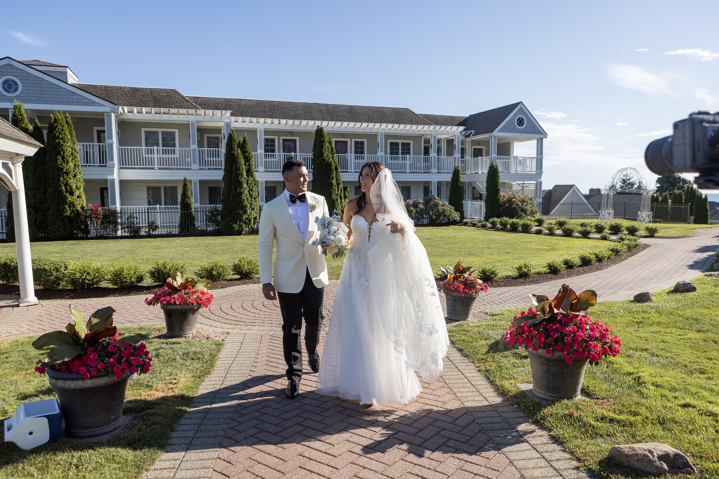 Bride and groom close-up portrait with garden-style white and blue bridal bouquet at Water's Edge Connecticut, florals by First Blush Floral Design
