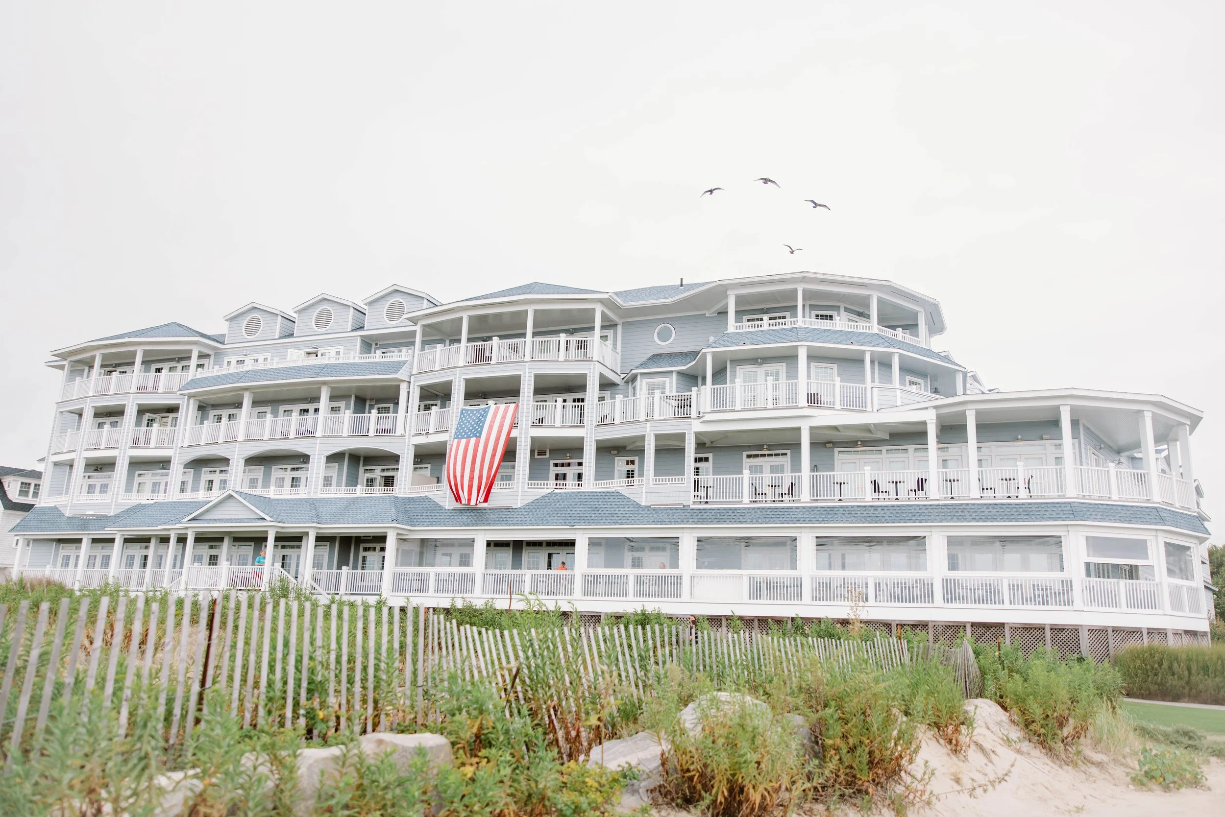 Sunset over Long Island Sound viewed from Madison Beach Hotel ballroom during coastal Connecticut wedding.